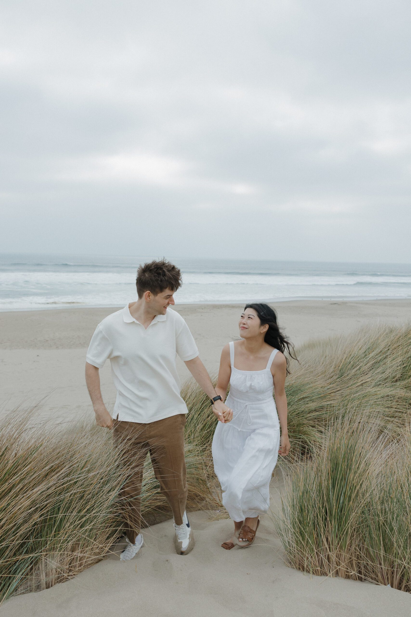 Couple walking on the beach holding hands