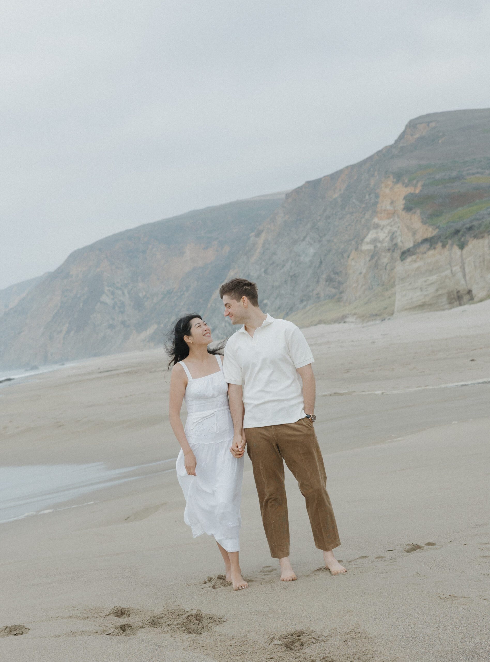 Couple smiling at each other at Point Reyes for engagement photos