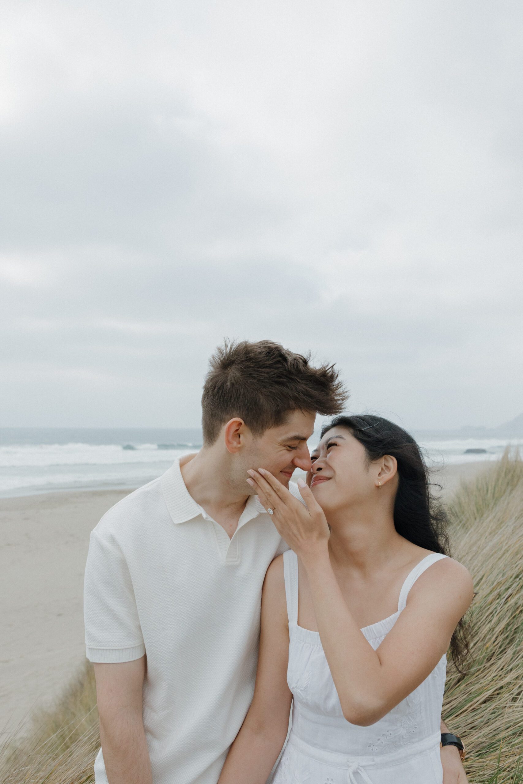 Girl holding her fiancé's face during engagement photos
