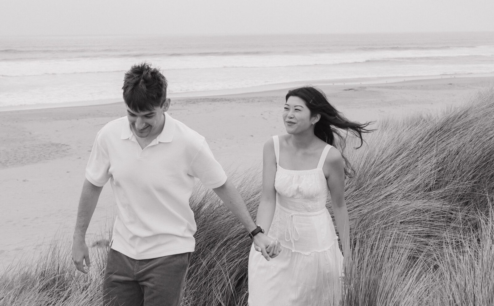 Black and white photo of couple during their beach engagement photoshoot