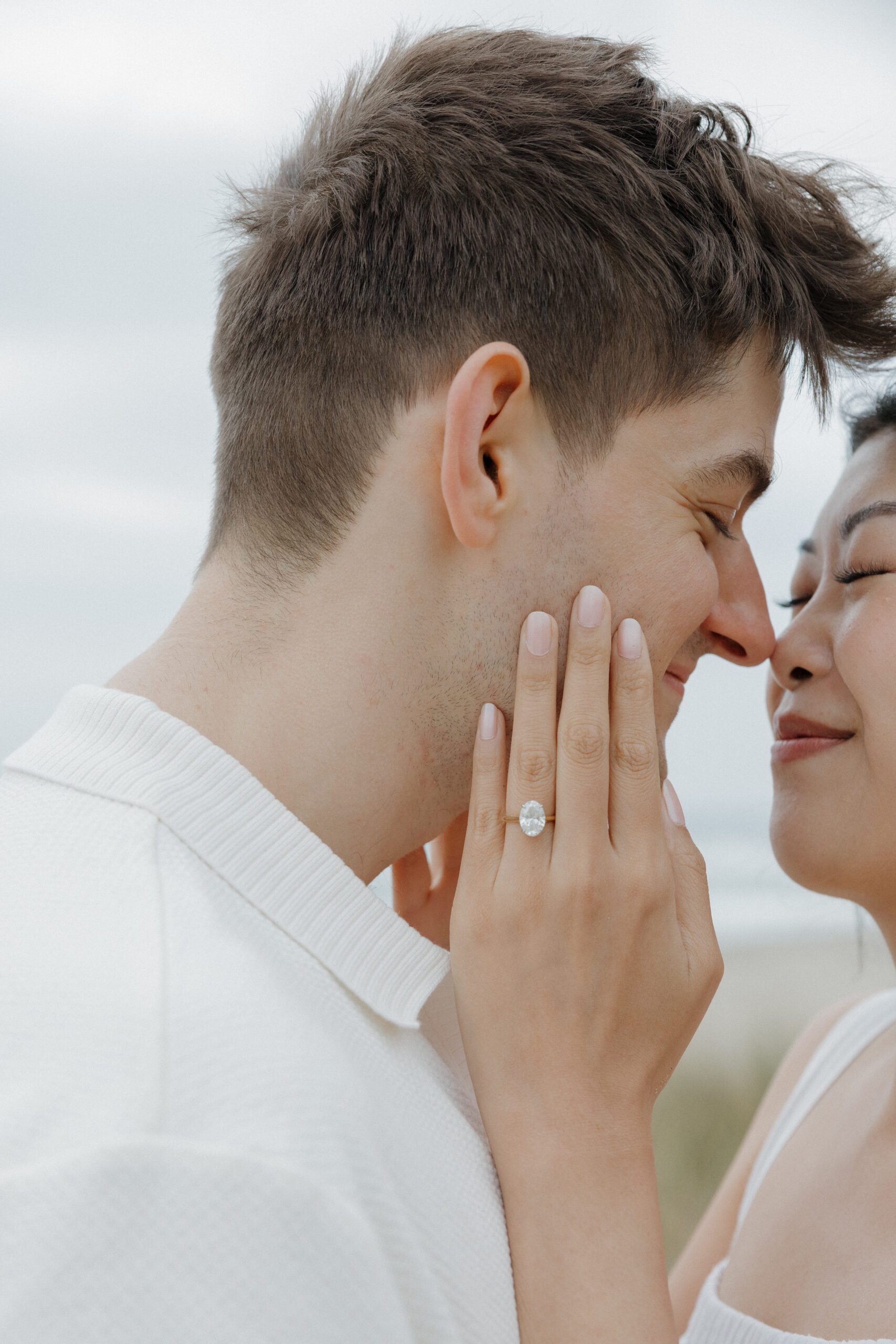 A couple posing for engagement photos with their noses touching
