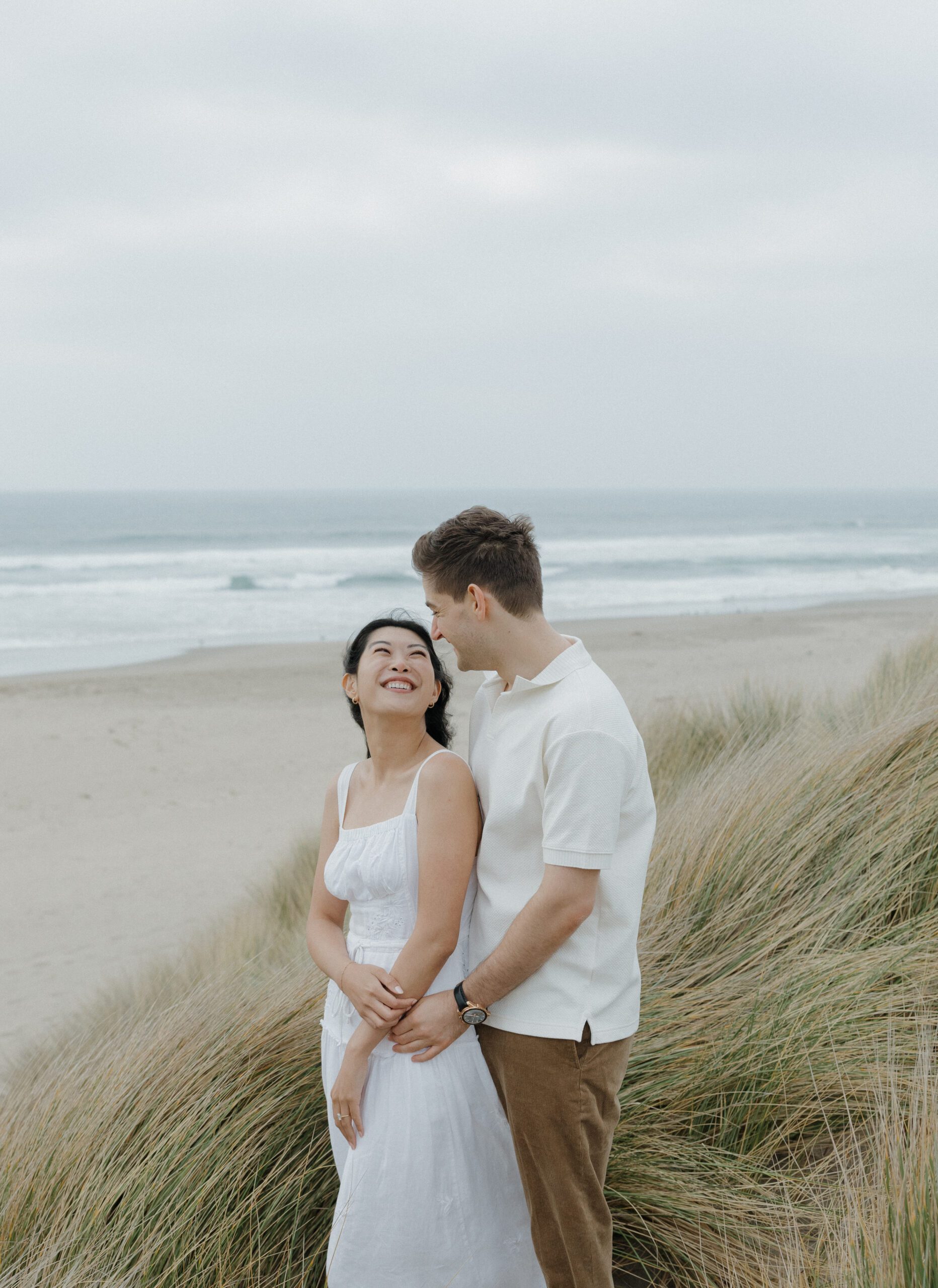 Girl smiling at her fiancé on the beach