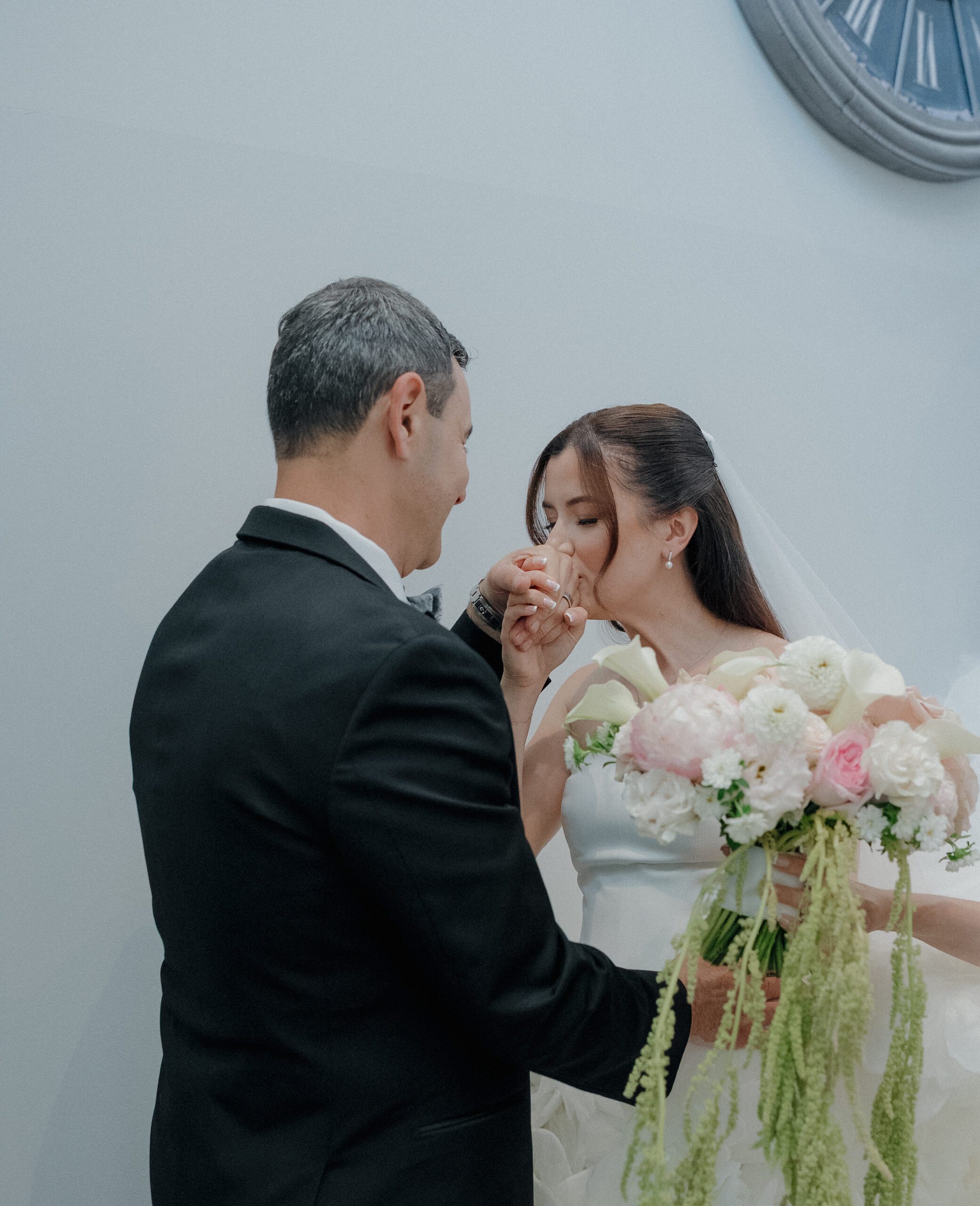 Bride kissing her dad's hand during first look