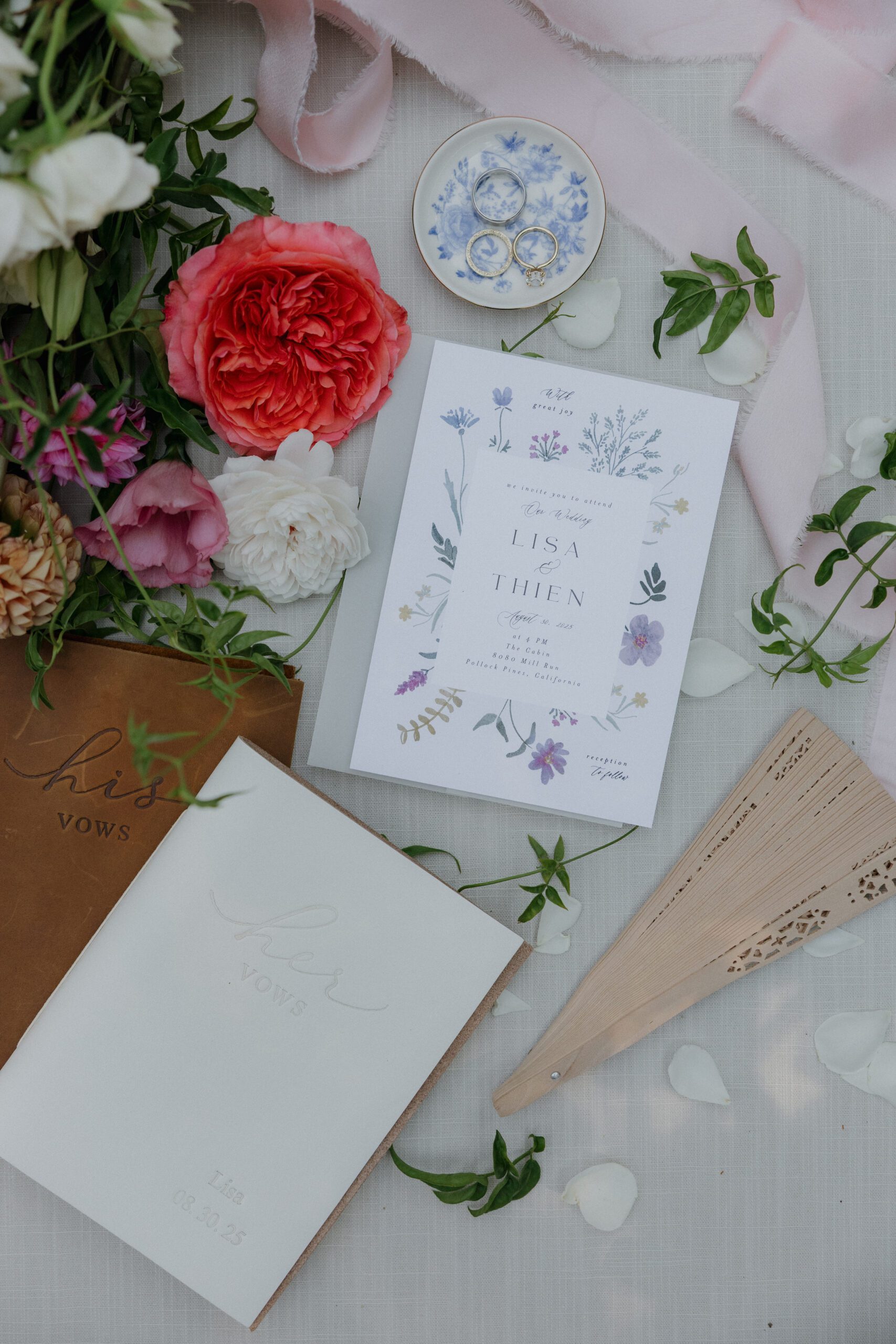 A wedding flat lay with flowers, invitations, and accessories