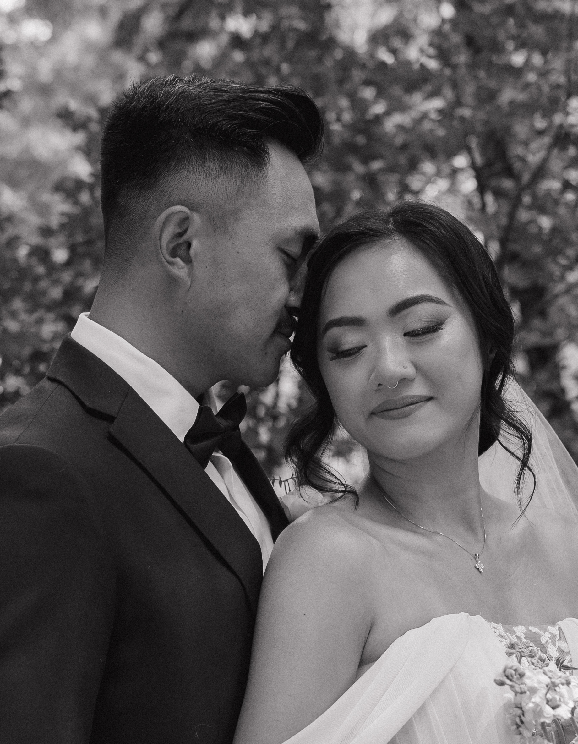 A black and white wedding portrait of a bride and groom at their wedding
