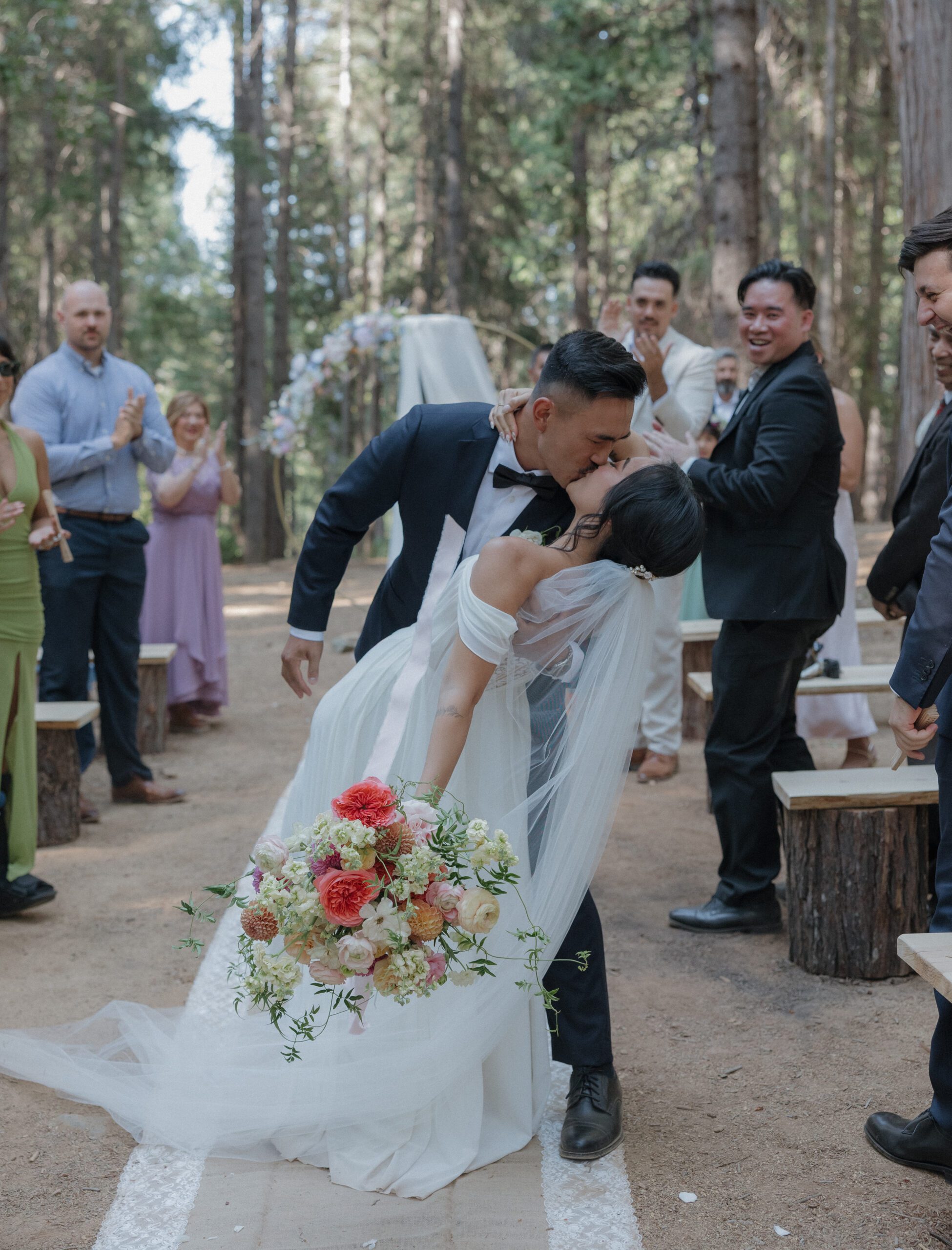 A couple kissing while exiting their intimate wedding ceremony