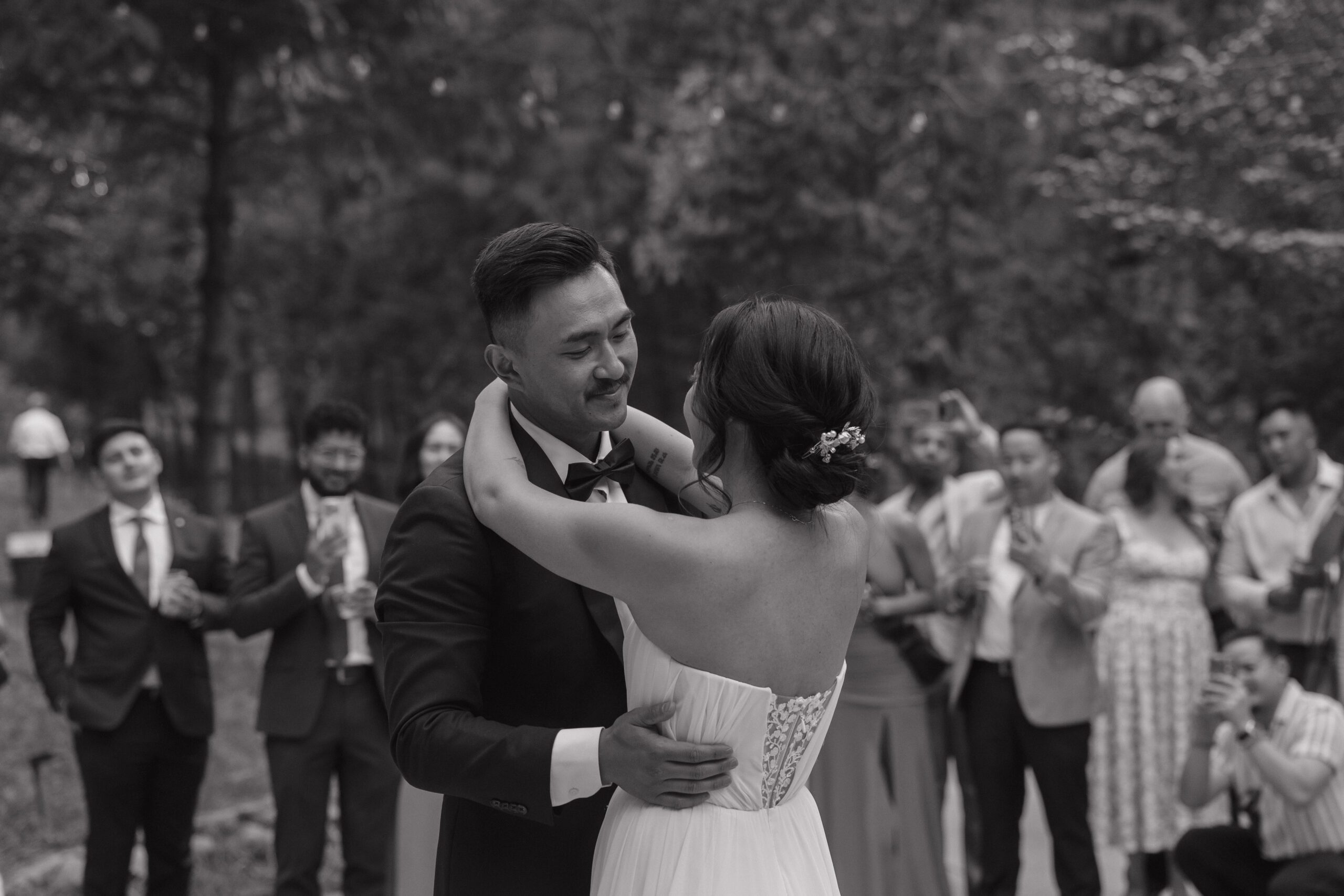 A black and white photo of a couple during their first dance at their intimate wedding