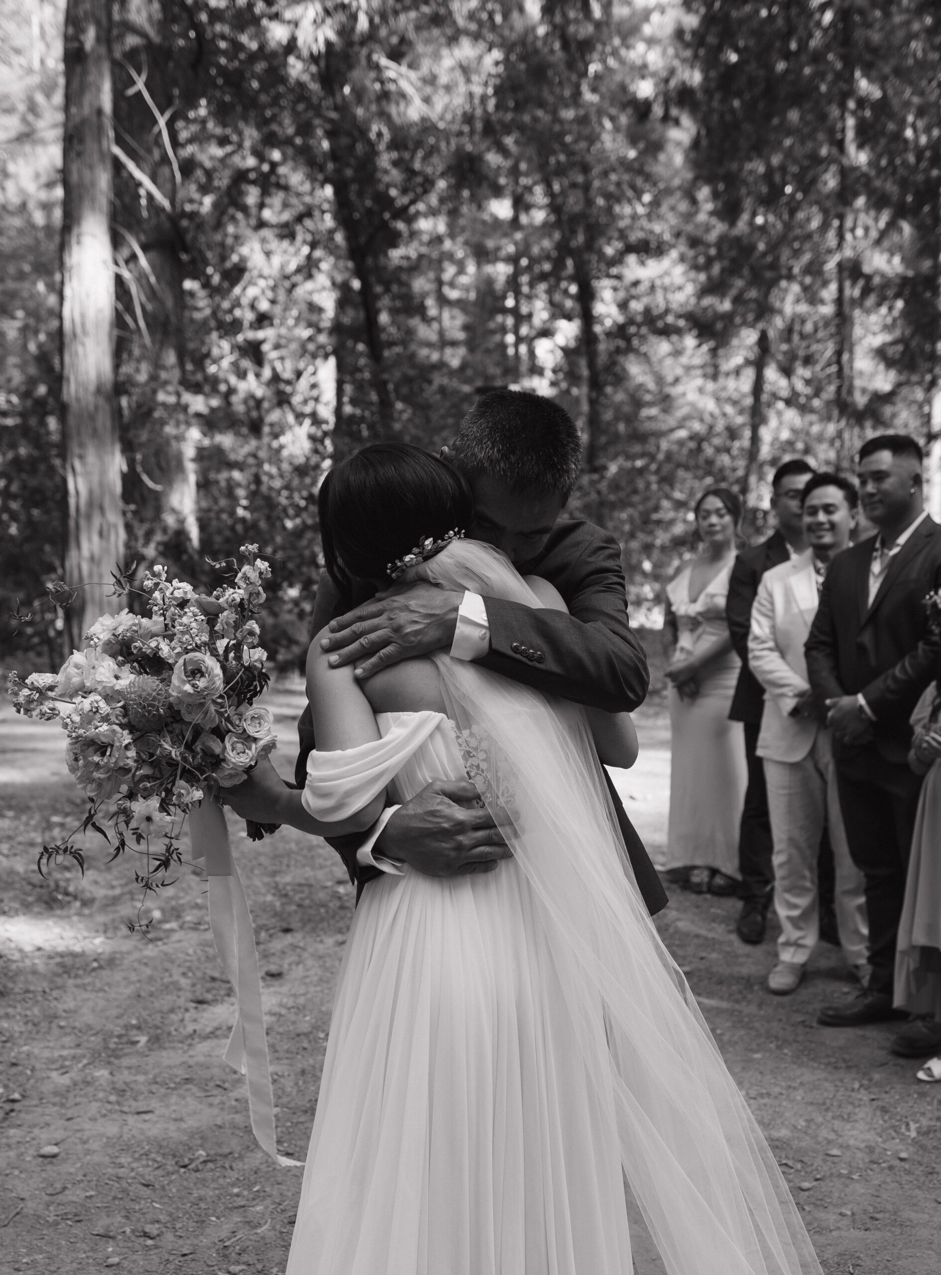 A bride hugging a wedding guest at an intimate wedding