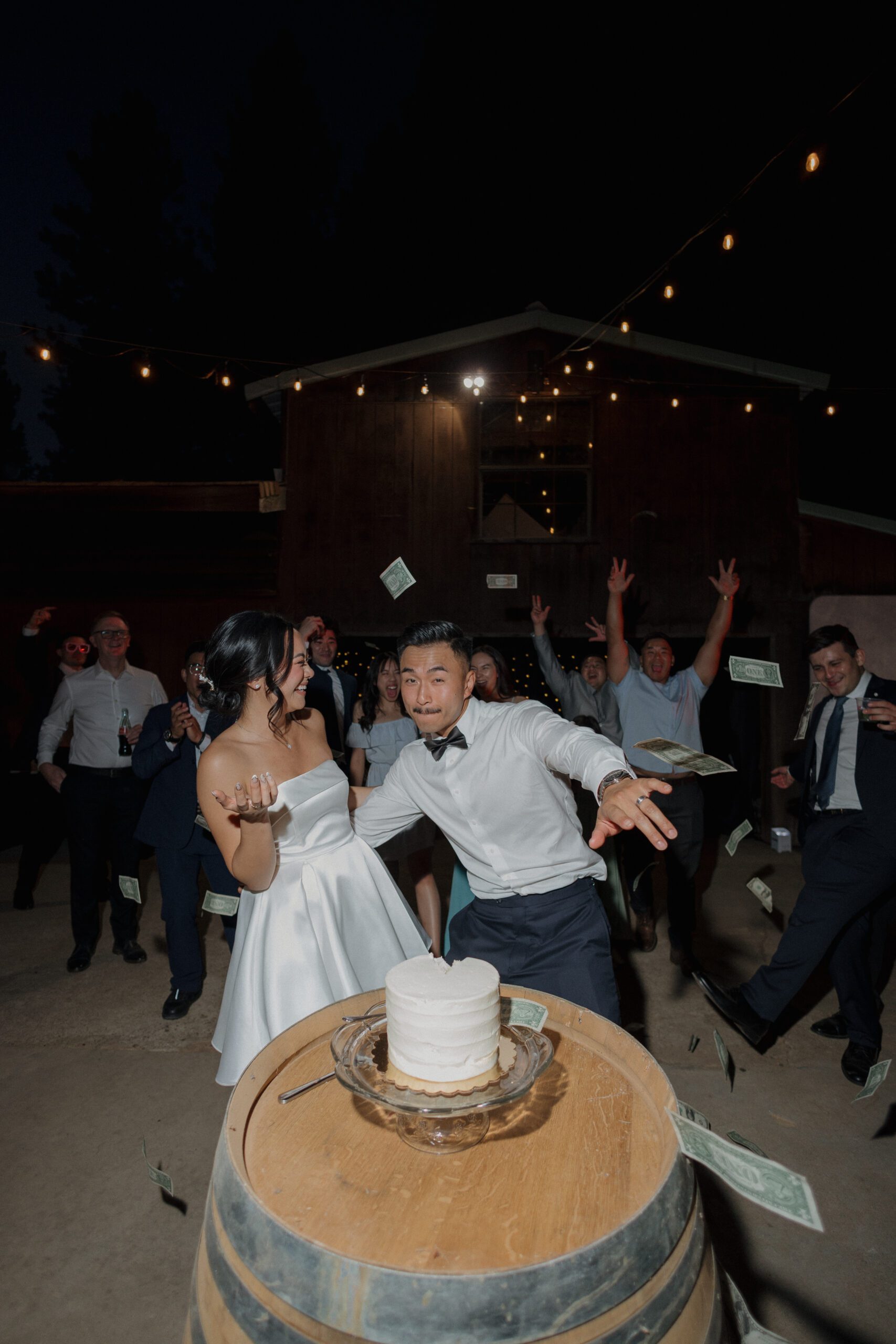 A candid photo of a bride and groom during their cake cutting