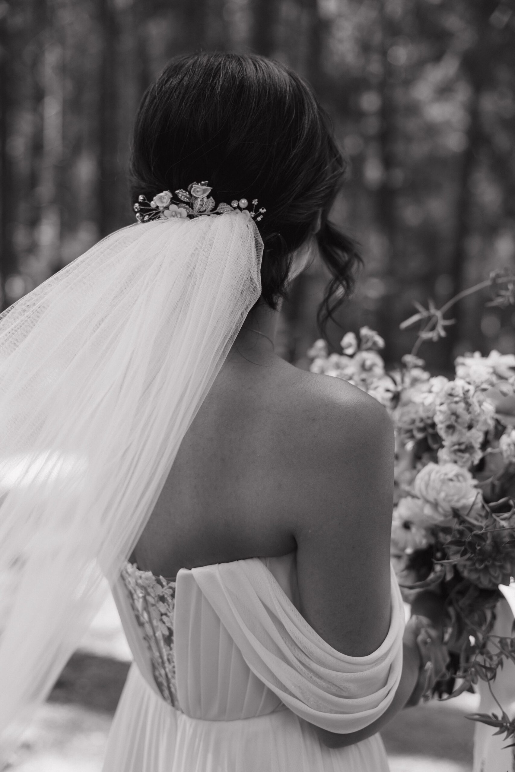 The back of a bride's intimate wedding dress plus a veil with a hairpiece
