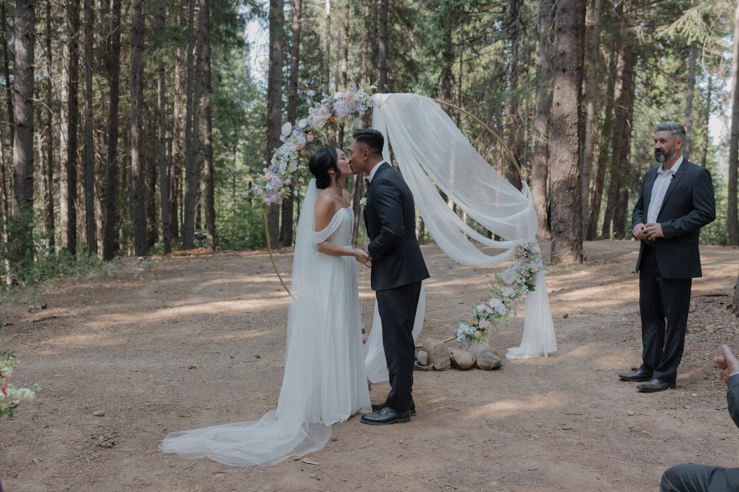 A couple sharing their first kiss as a married couple