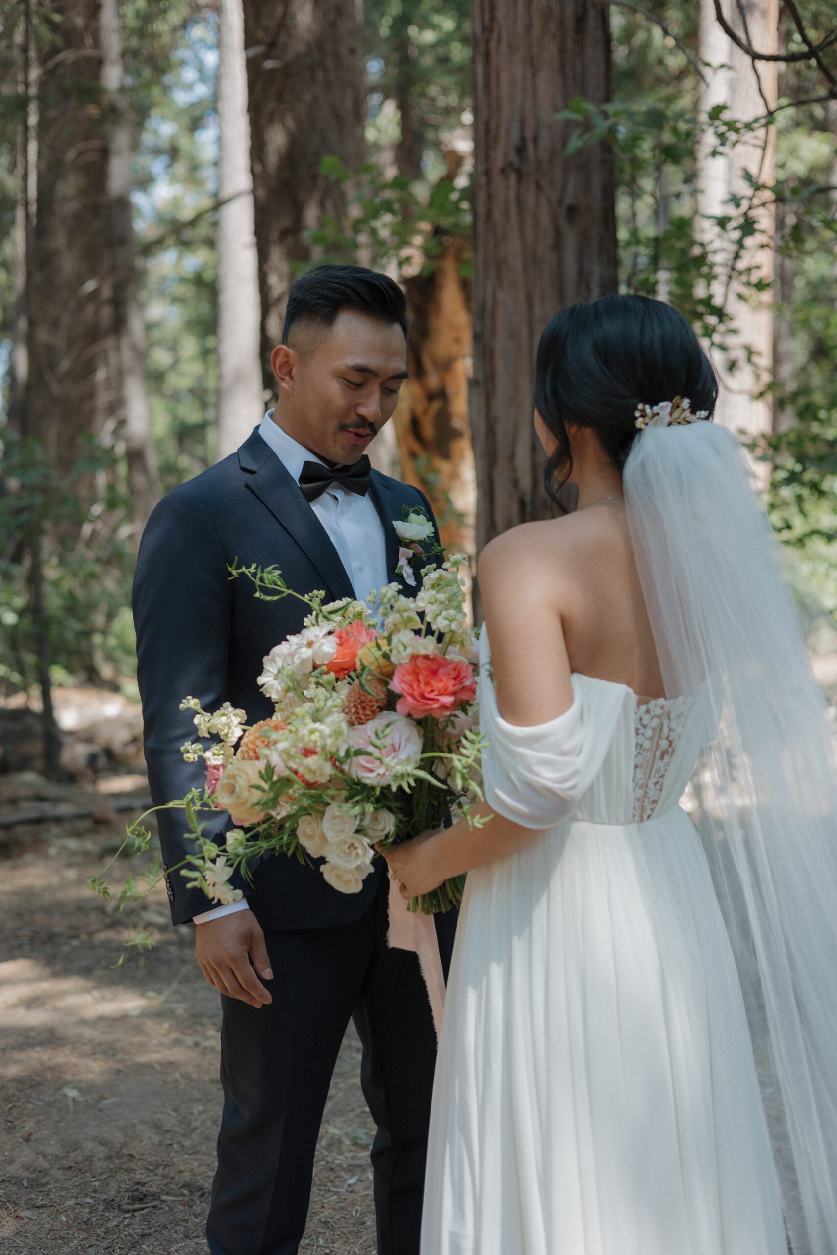 A groom looking at his wife during a wedding first look