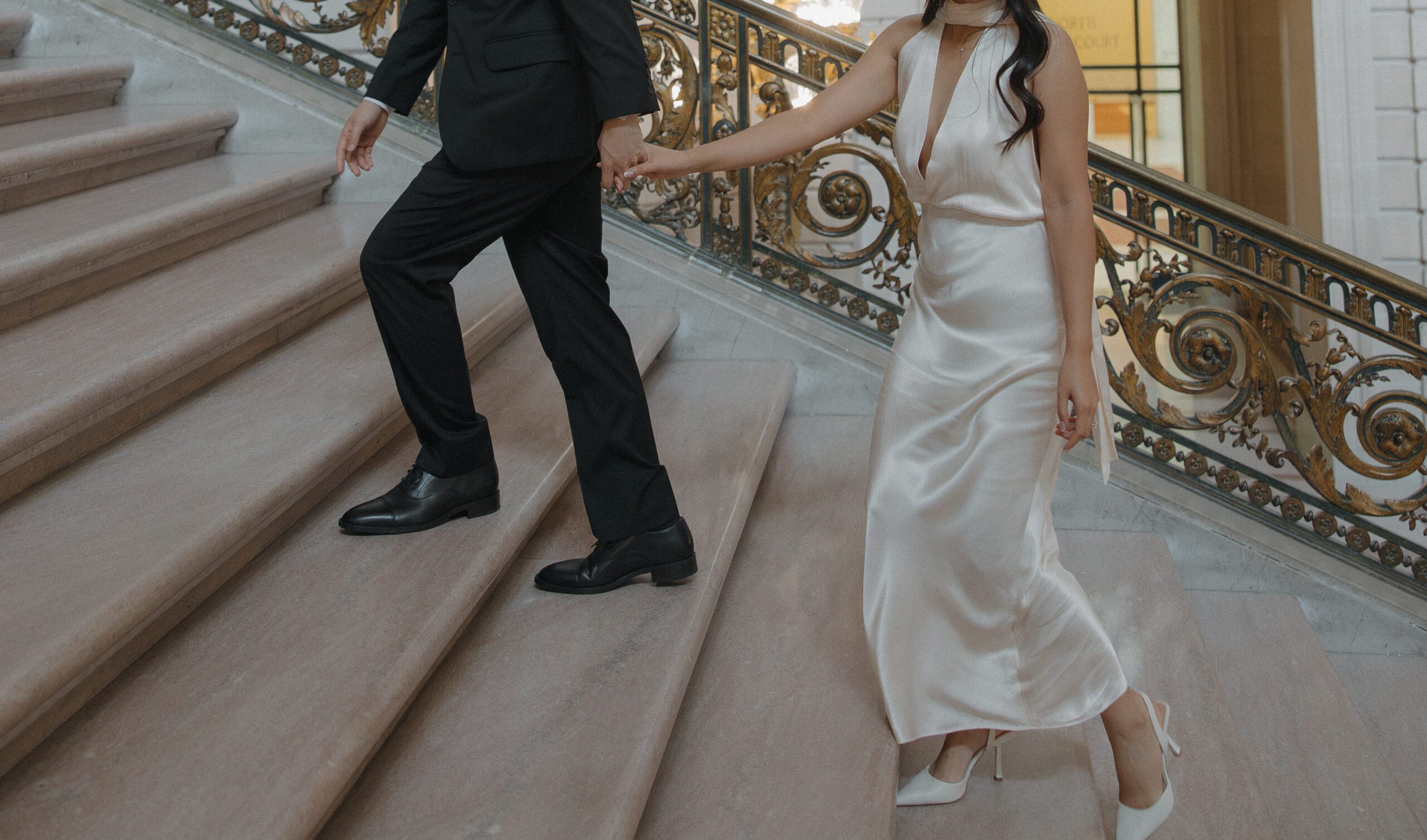 A couple's engagement photoshoot outfits, a sleek white dress and a black suit