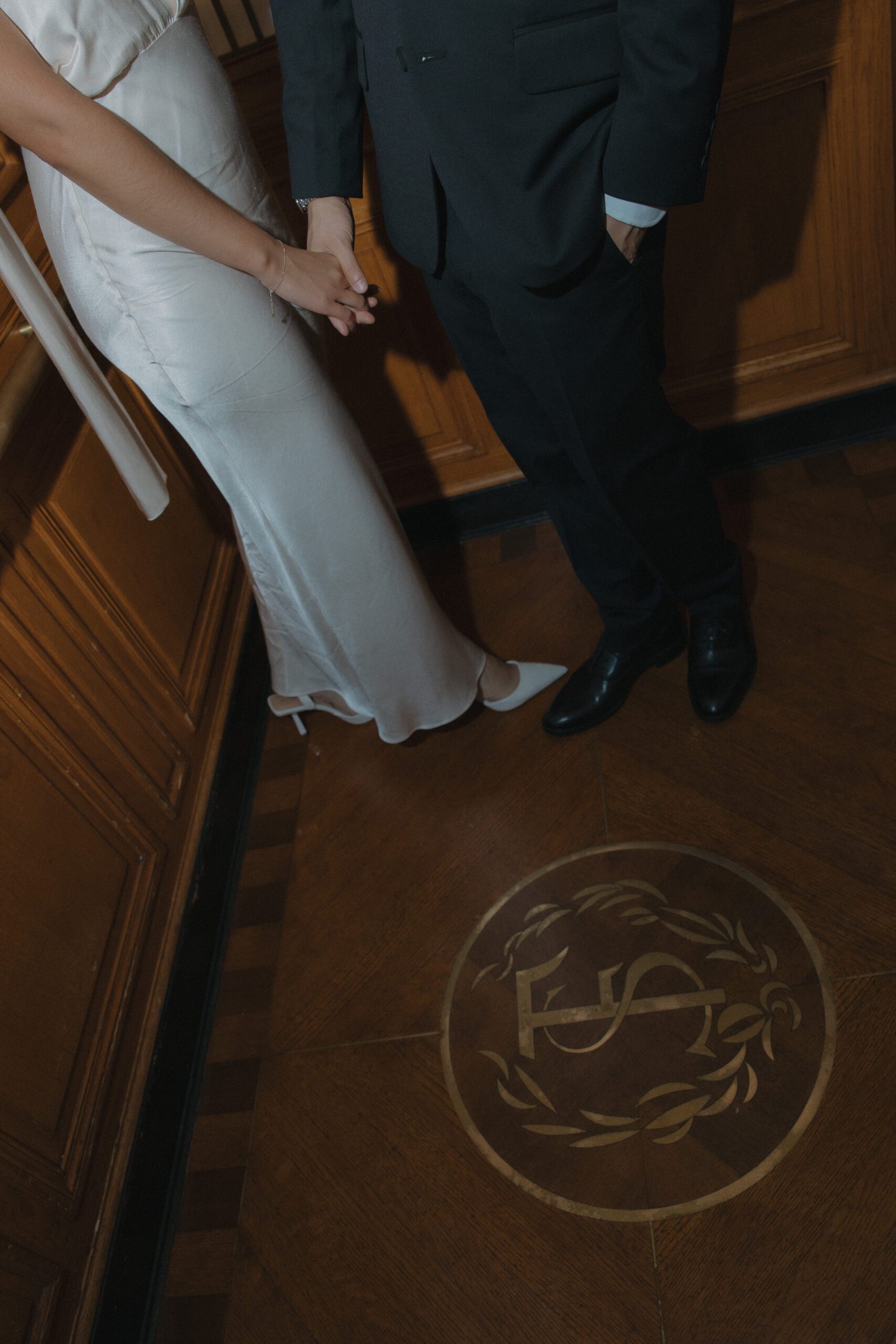 A couple's lower halves in an elevator as a San Francisco City Hall photo