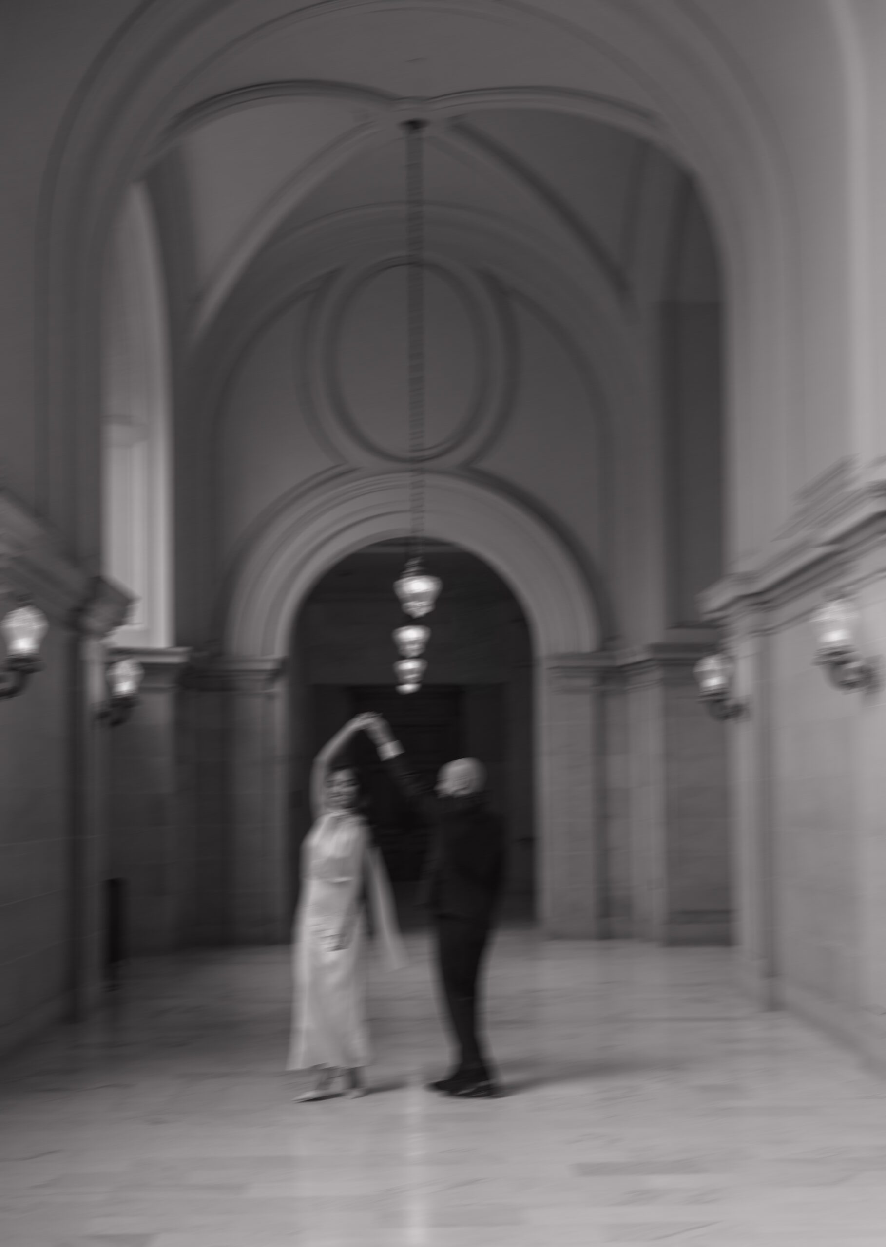 A blurry, editorial engagement photo from an engagement photoshoot at SF City Hall