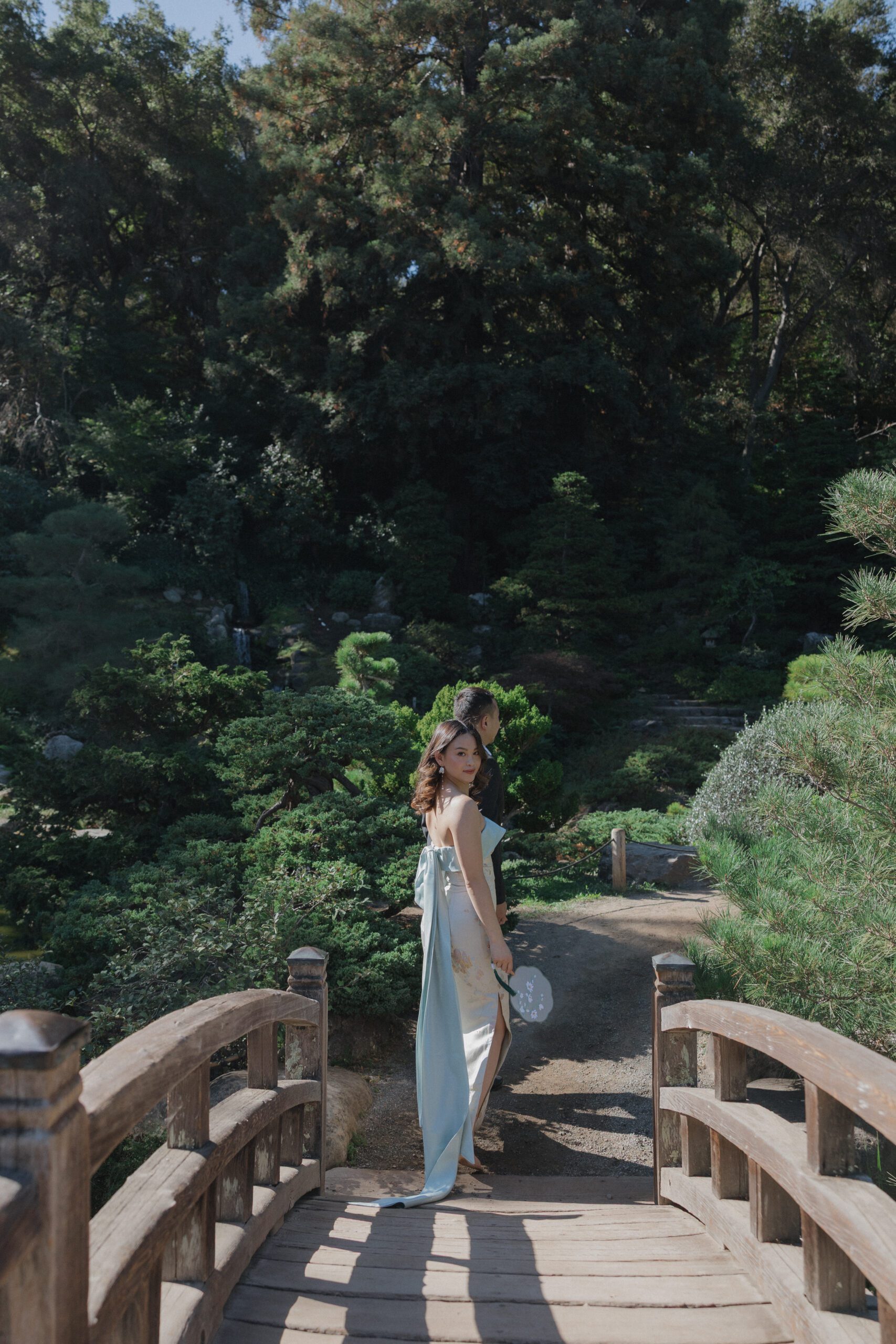A couple walking across the Moon Bridge at Hakone Estate and Gardens