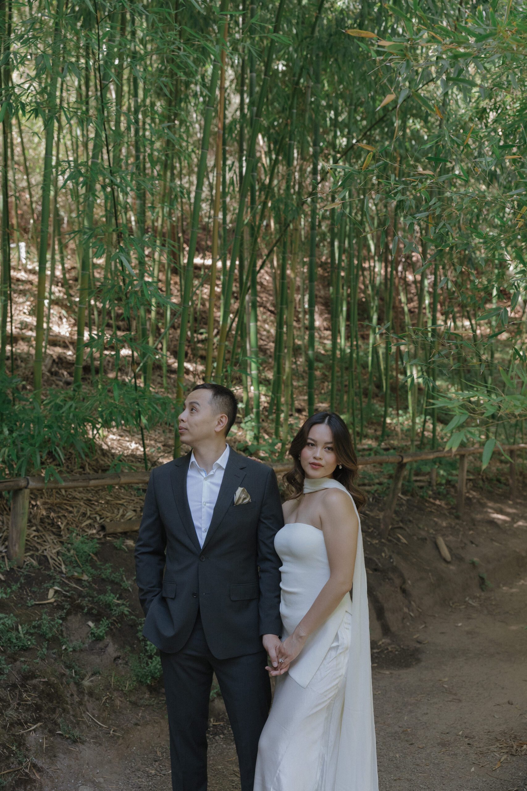 A couple posing for engagement photos in the Bamboo Garden at Hakone Estate and Gardens