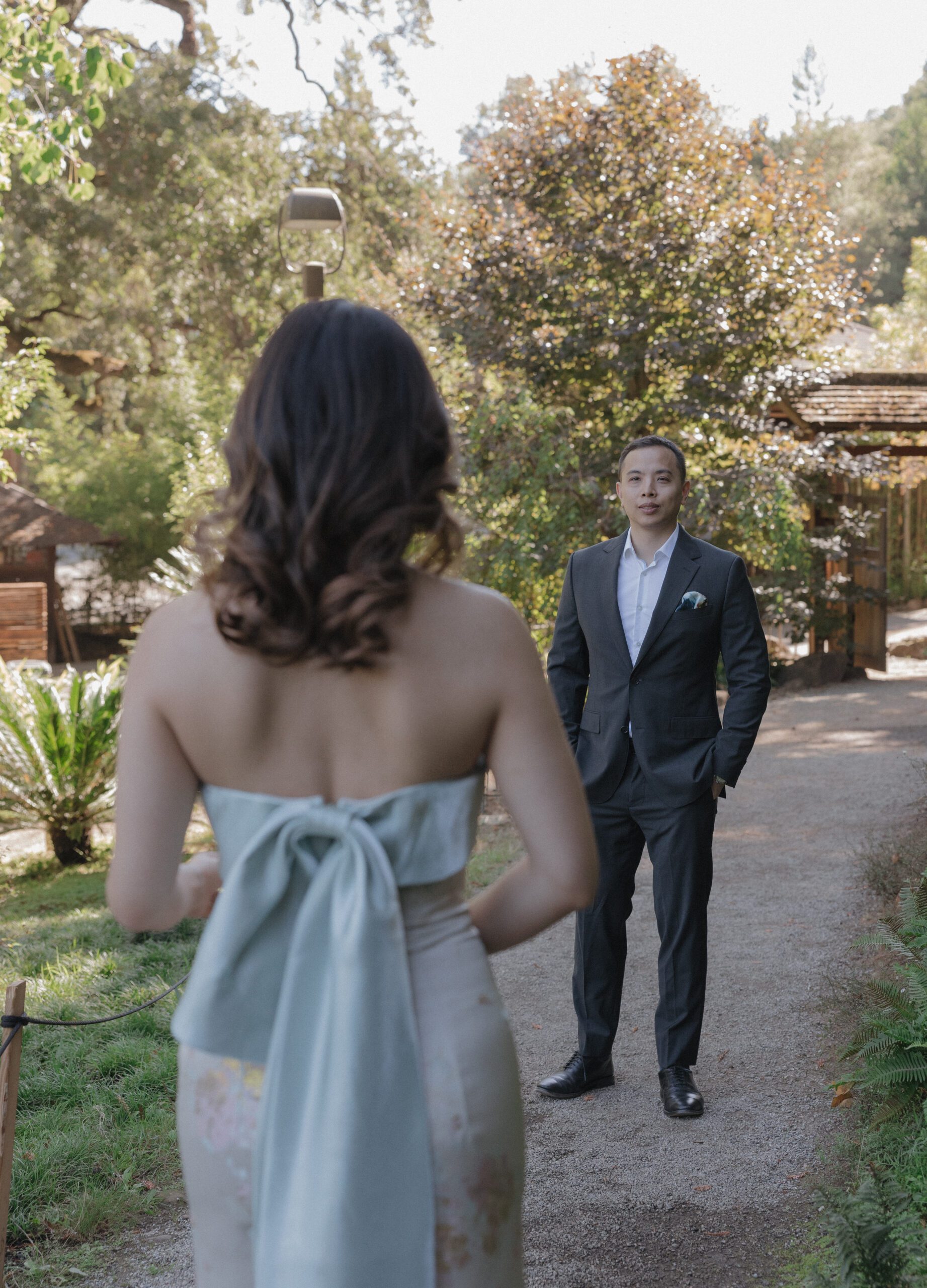 A man staring at his fiancee, who's back is to the camera