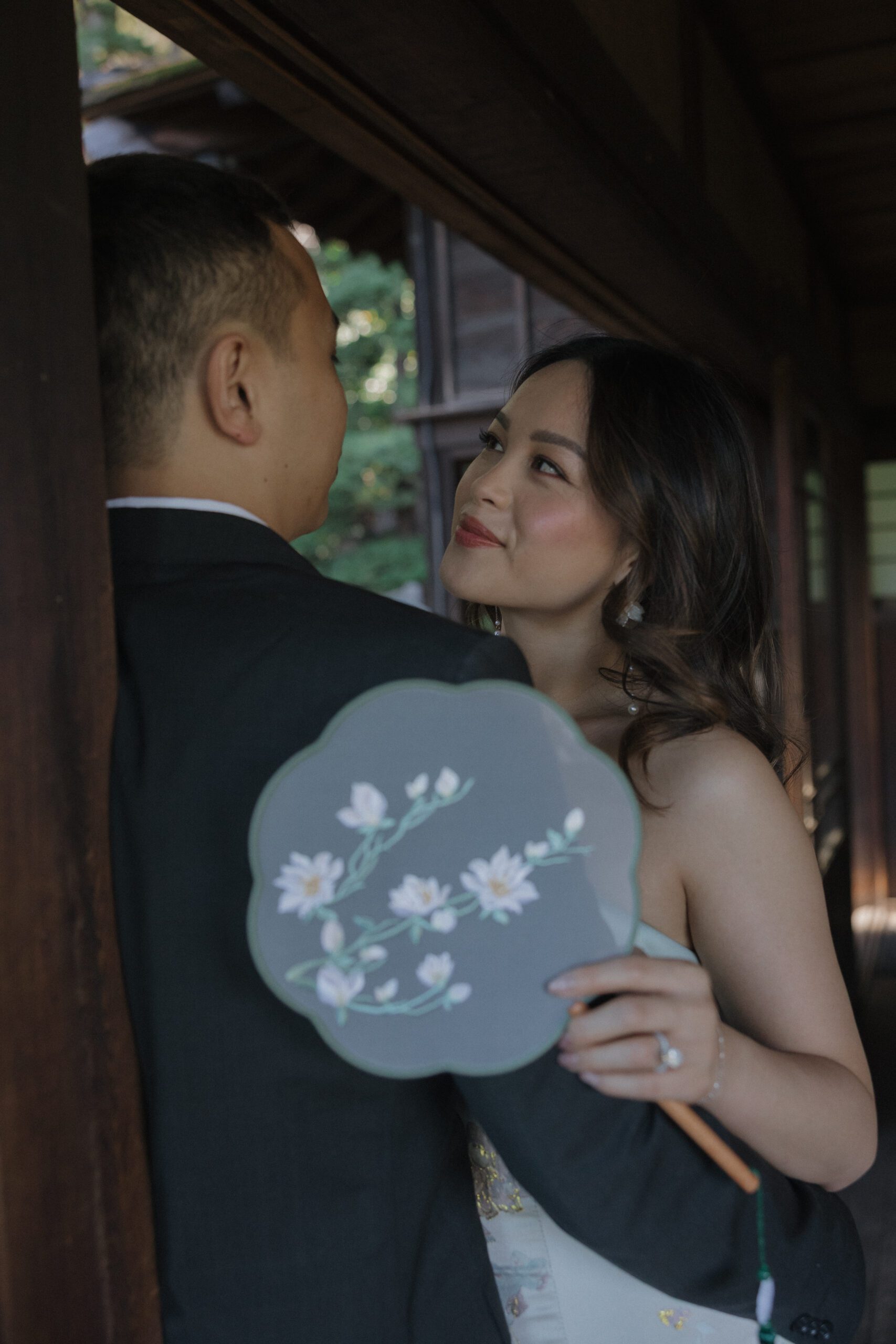 A woman smiling at her fiancé during engagement photos