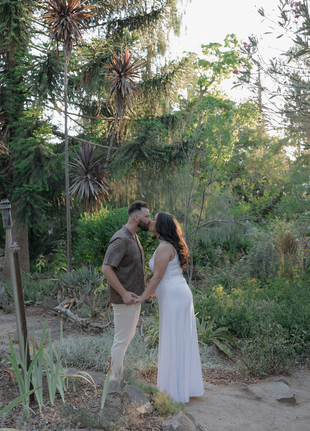 A couple kissing in the gardens in William land park engagement photos