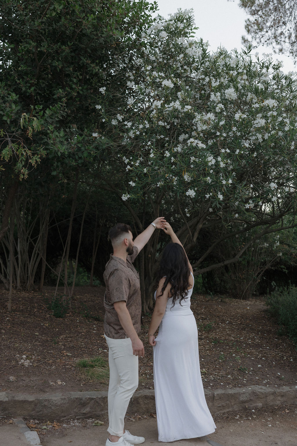 A couple dancing in William Land Park in Sacramento for engagement photos