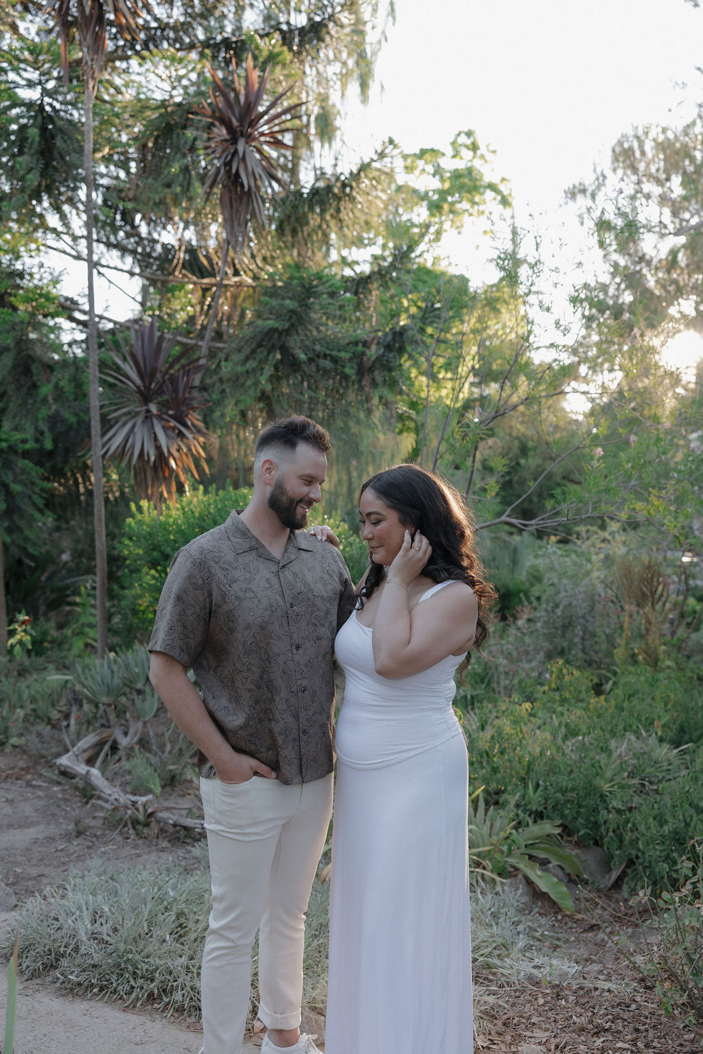 A couple posing for engagement photos at William land park