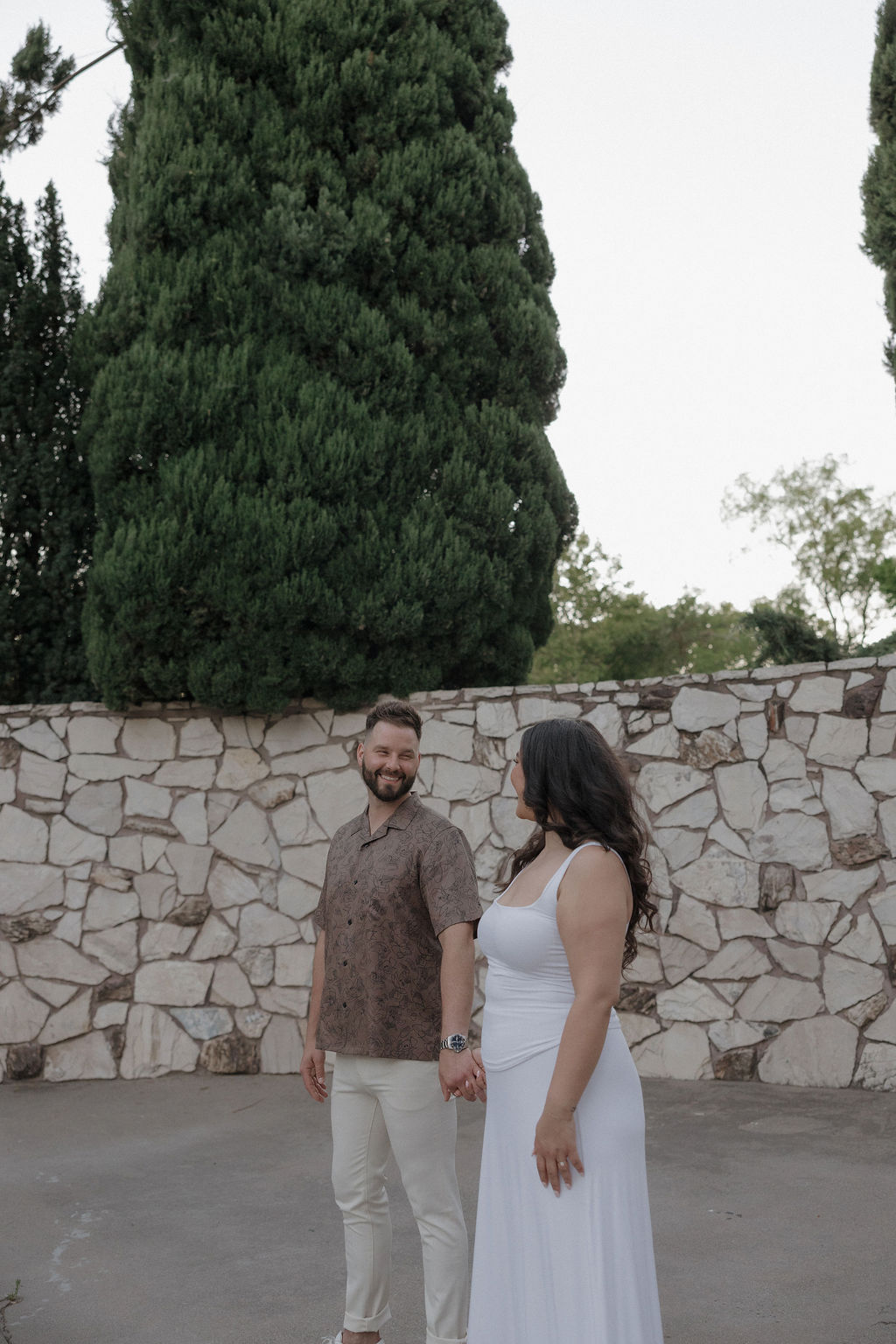A couple posing for photos at their engagement photo location