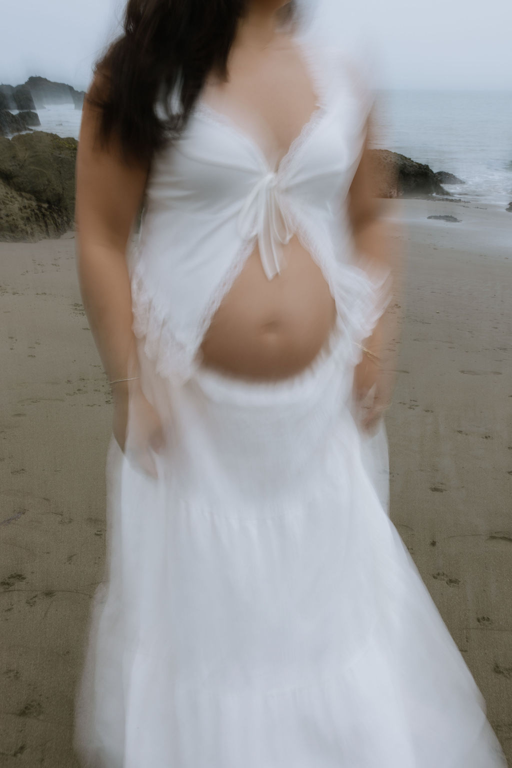 A flurry photo of a woman's maternity photoshoot outfit