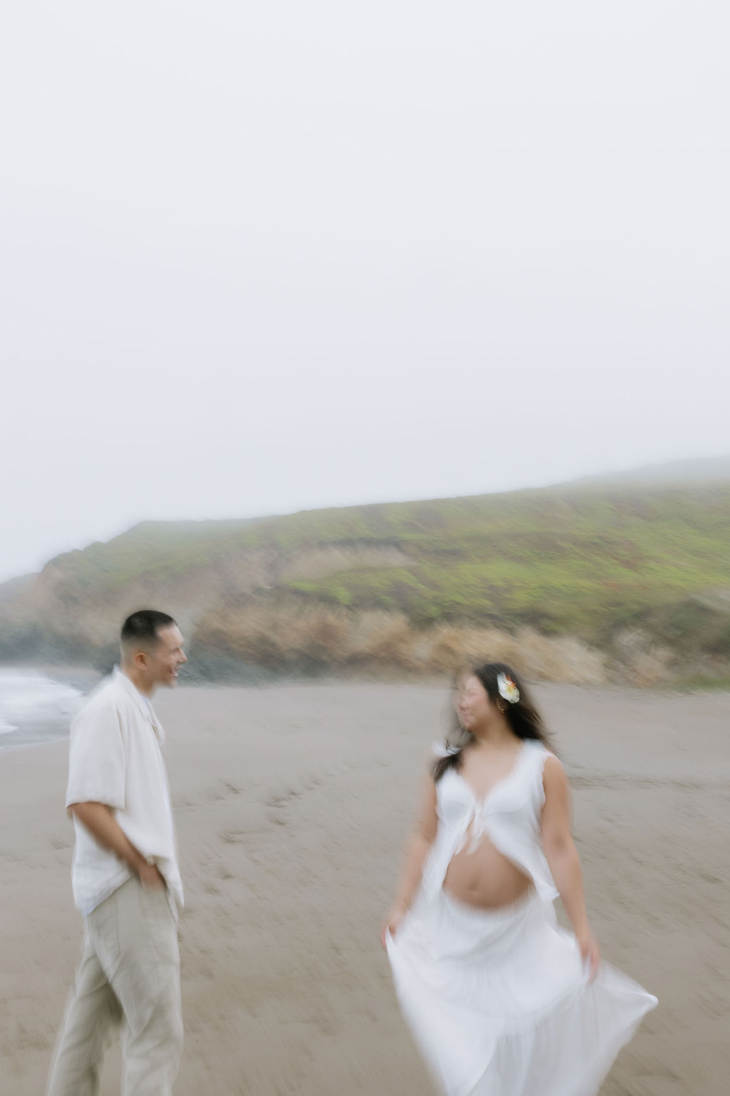 A couple dancing on the beach during maternity photos at South Rodeo beach