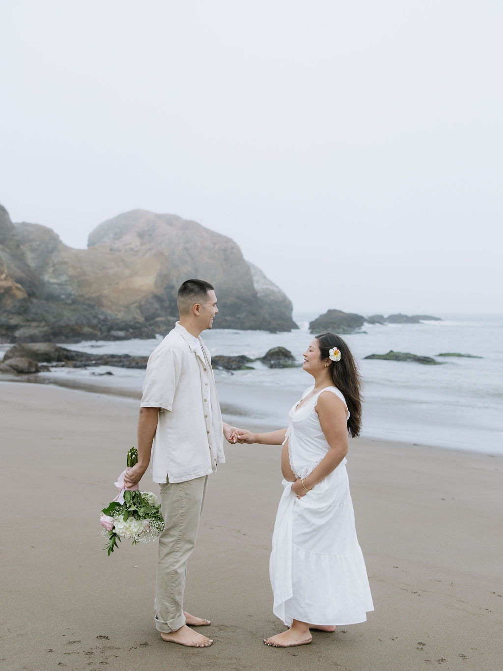 A man giving a woman flowers during her maternity photoshoot 