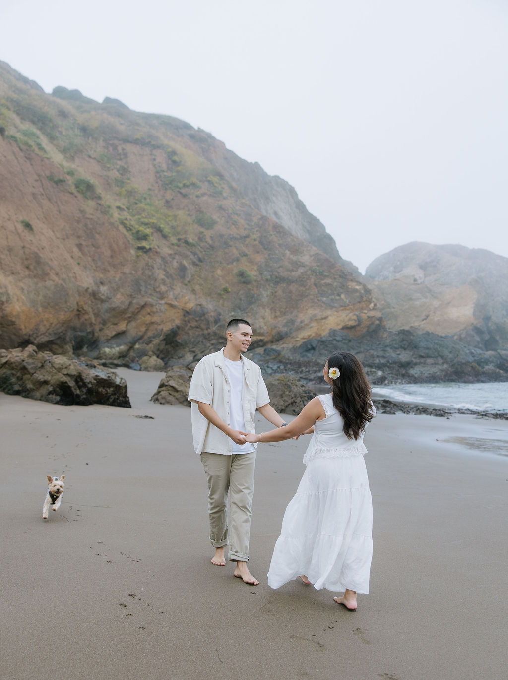 A couple dancing on the beach during maternity photos at South Rodeo beach