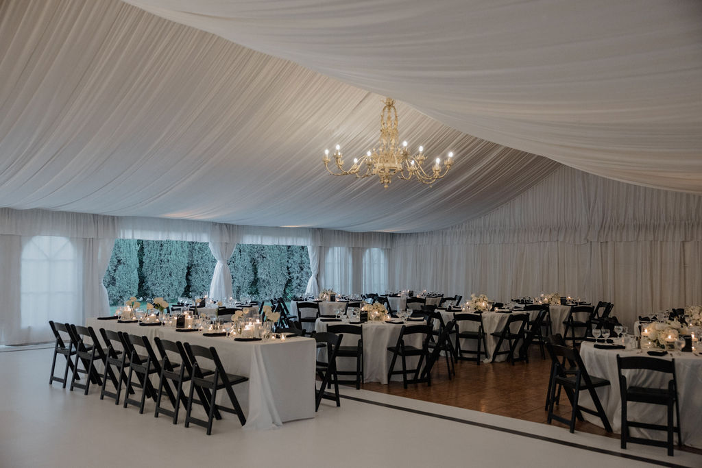 A wedding reception set up underneath a tent at grand island mansion