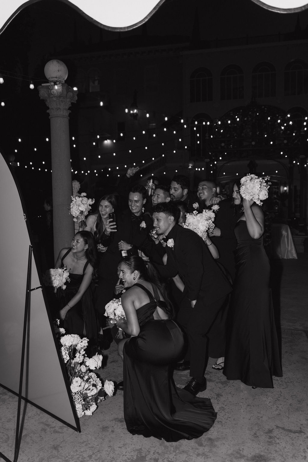 Wedding guests taking a mirror selfie in a welcome sign