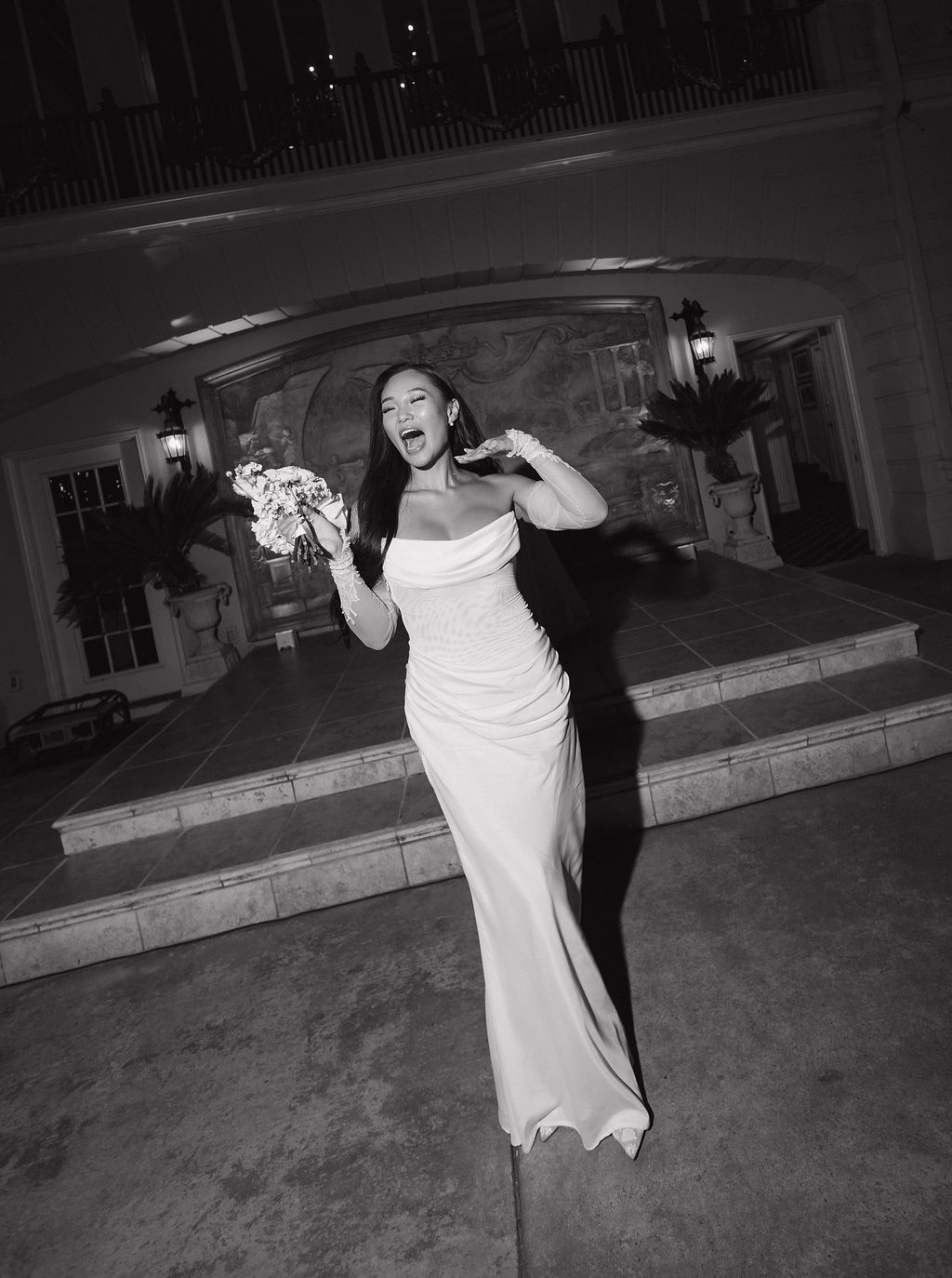 A black and white photo of a bride who changed into a wedding reception dress at grand island mansion