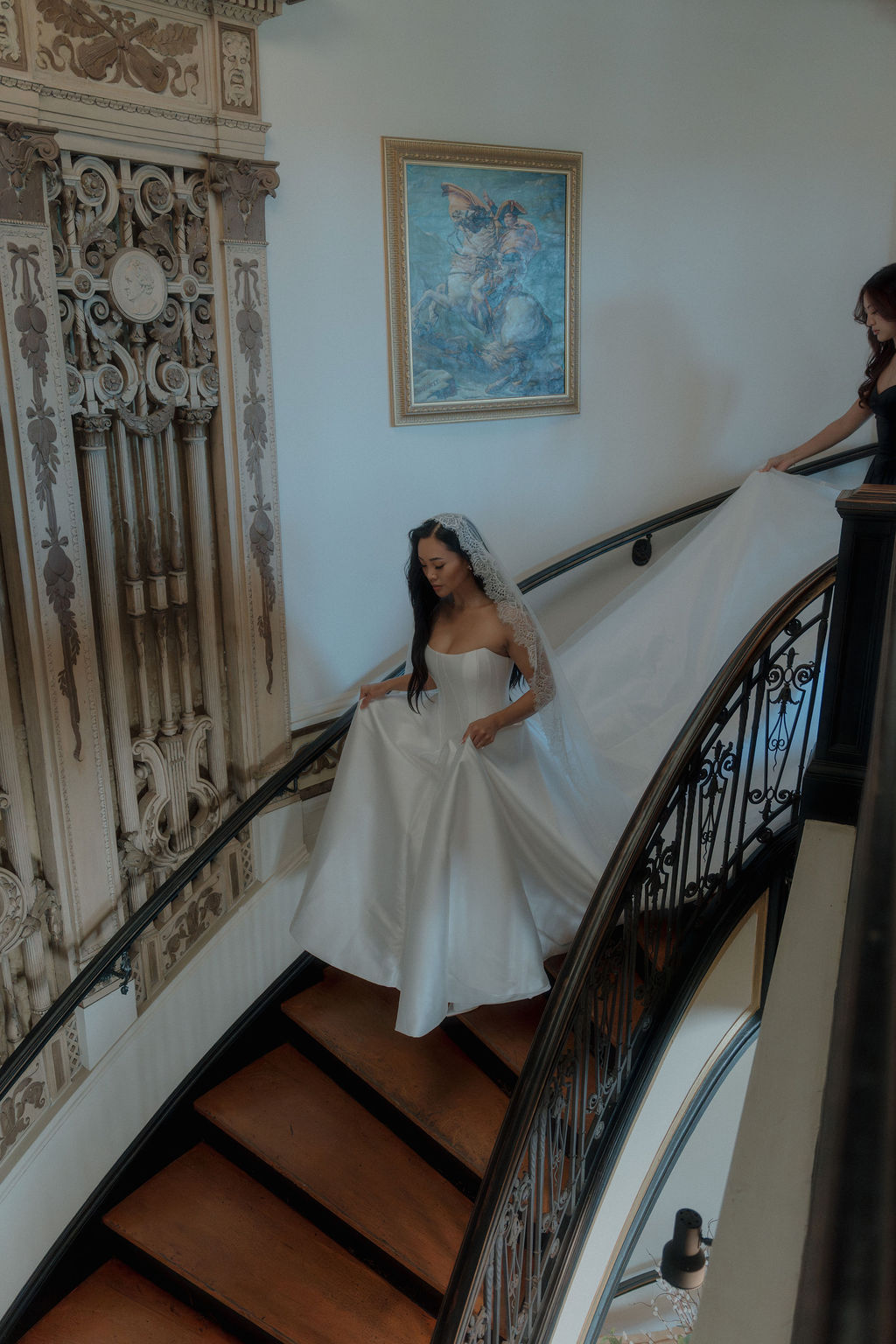 A bride walking down the stairs inside grand island mansion