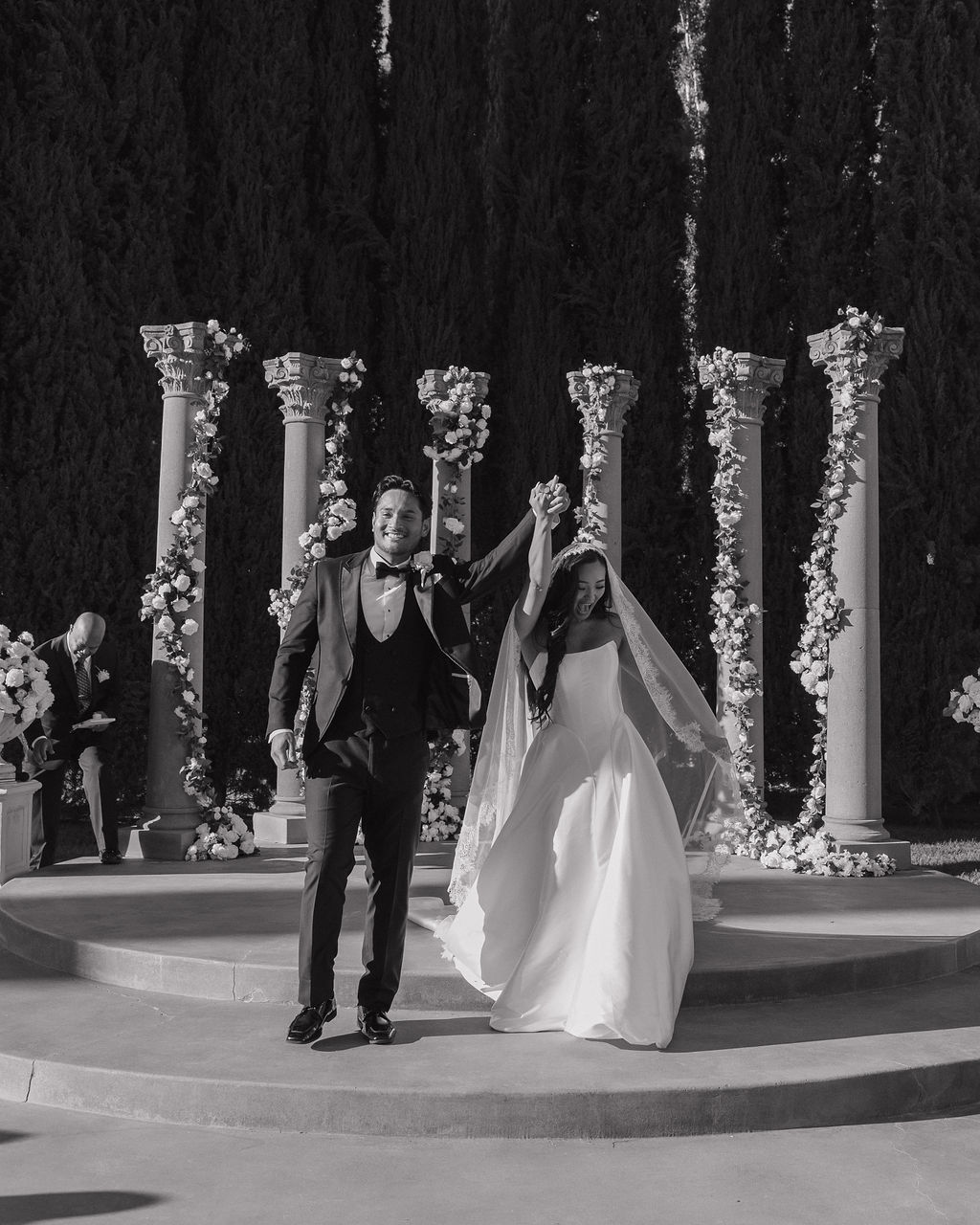 A couple cheering after their wedding ceremony