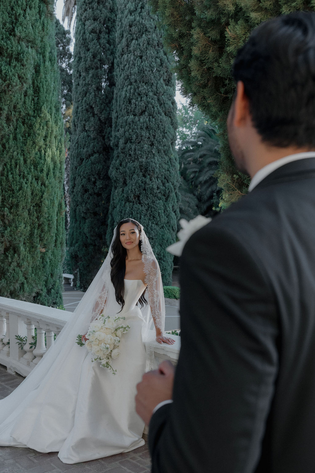 A bride smiling at a groom during wedding portraits on the balcony at grand island mansion