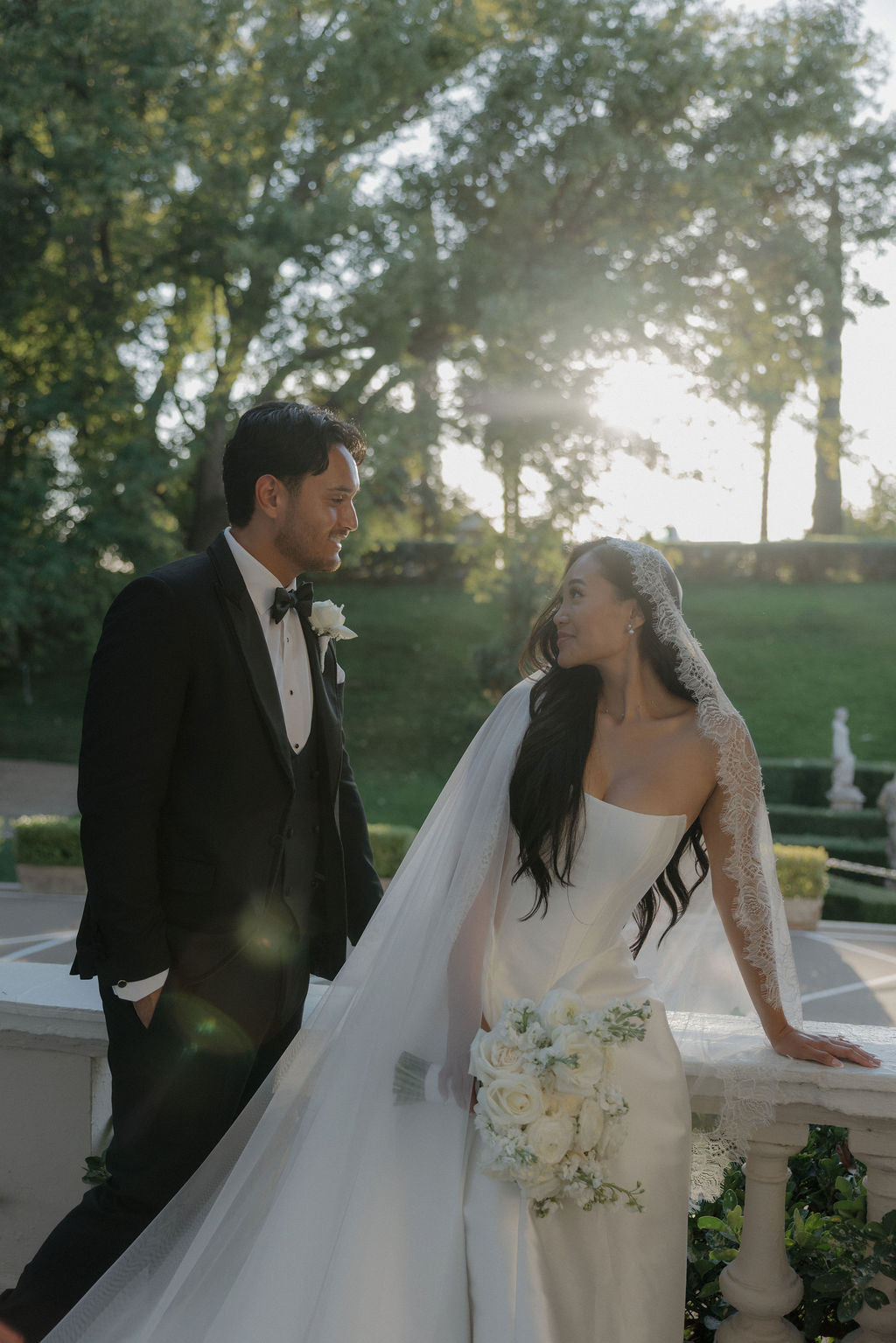 A couple smiling at each other on the balcony at grand island mansion
