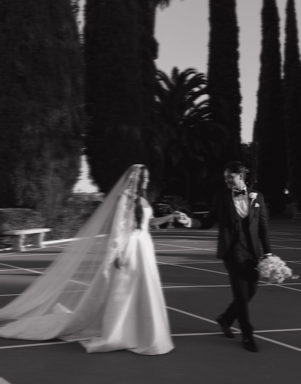 A bride and groom walking across the lawn at grand island mansion