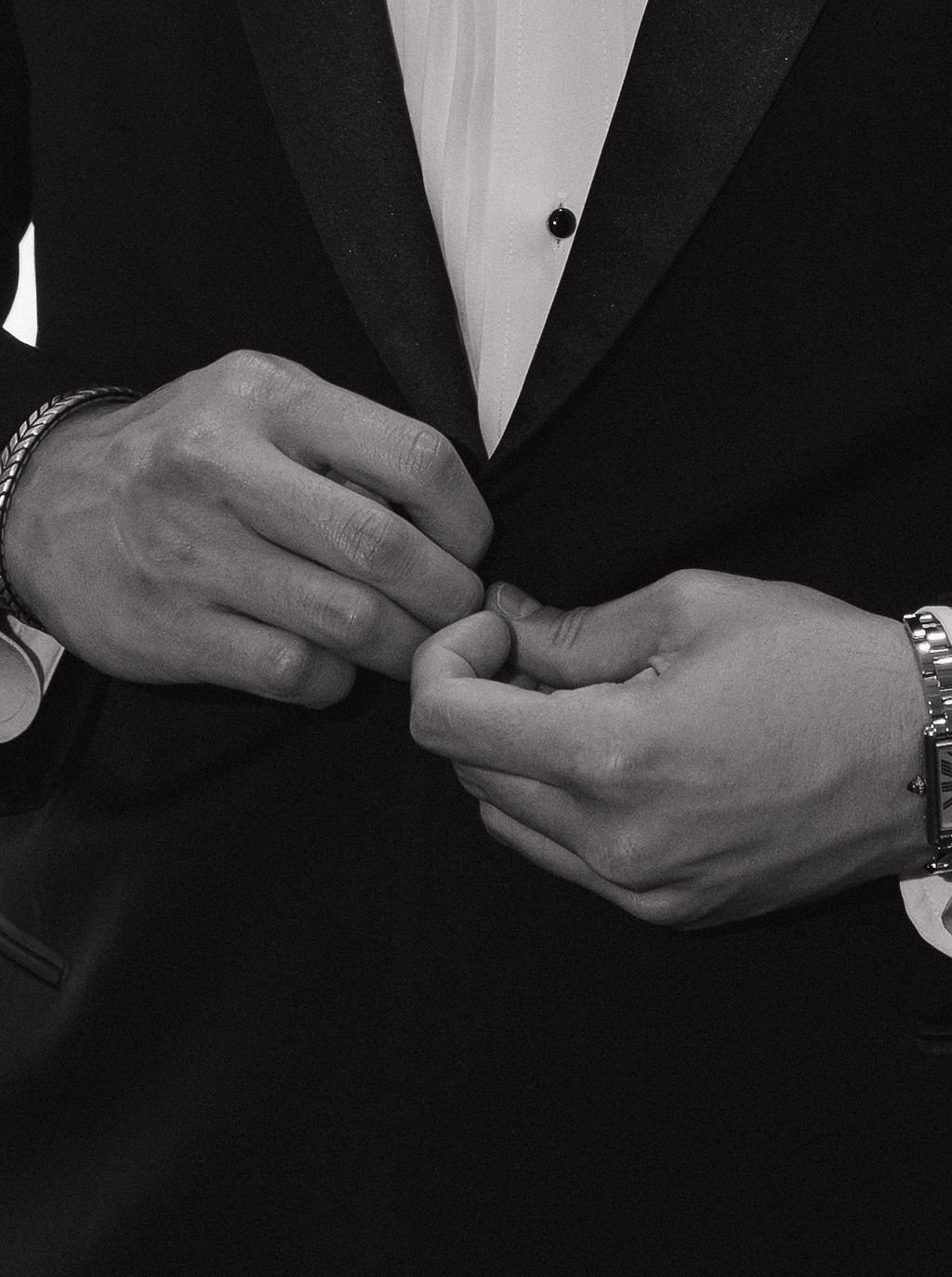 A groom showing luxury wedding ideas in his black tuxedo