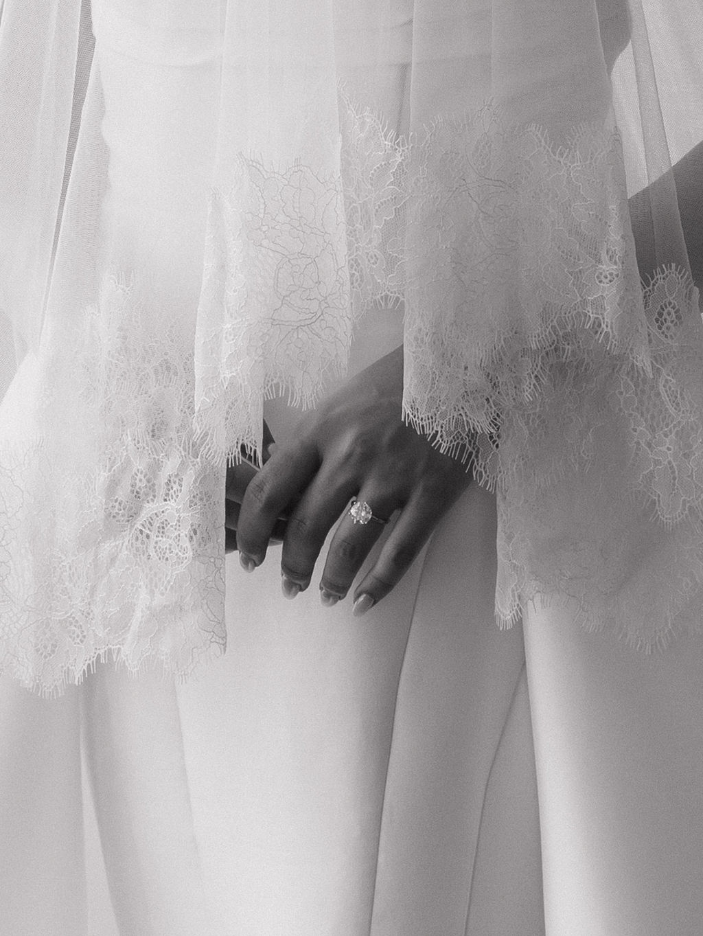 An up close photo of a bride's ring and veil, showing luxury wedding ideas