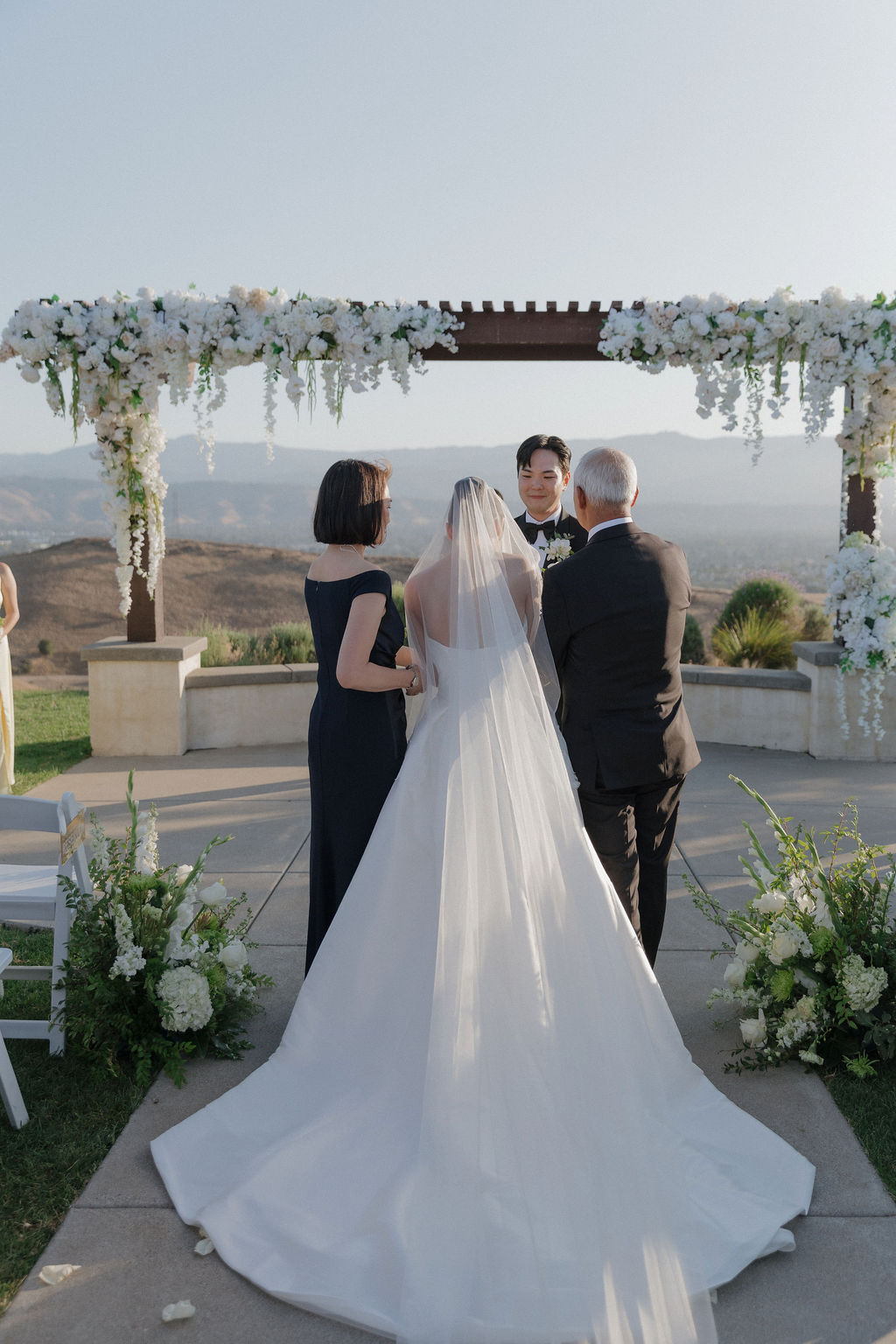 A bride's parents walking her down the aisle