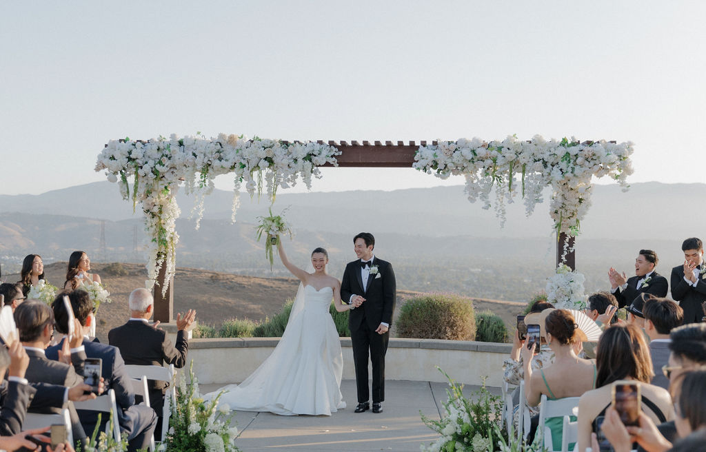 A bride and groom exiting their wedding ceremony full of luxury wedding ideas