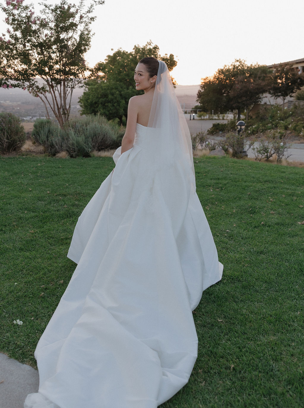 A bride walking with her wedding dress train trailing behind her