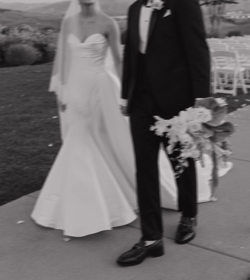 A candid wedding photo of a bride and groom walking, showcasing editorial wedding photos as a luxury wedding idea
