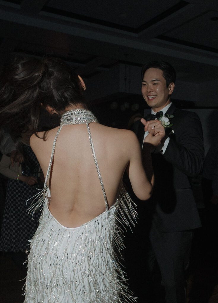 A bride and groom dancing at a wedding reception, giving off luxury wedding ideas