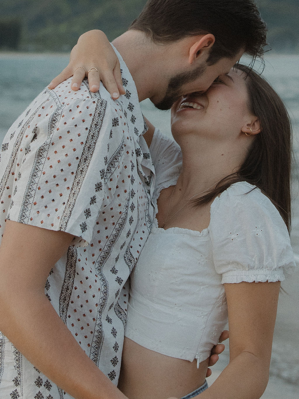 A couple leaning in for a kiss during engagement photos by a Kauai photographer