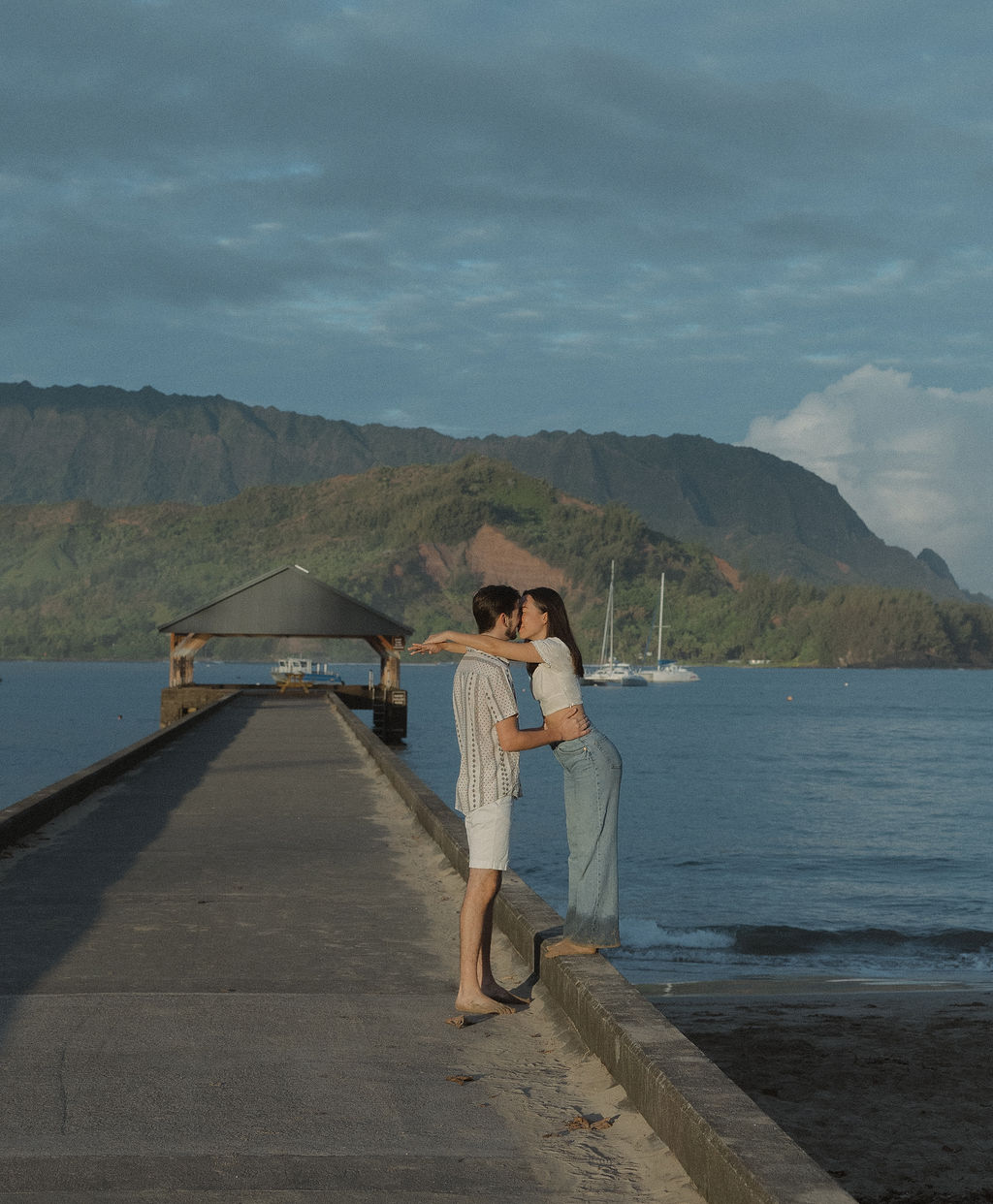 A couple kissing on Hanalei Bay Pier