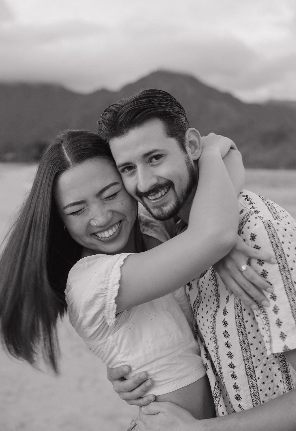 A black and white photo of a couple hugging taken by a Kauai photographer
