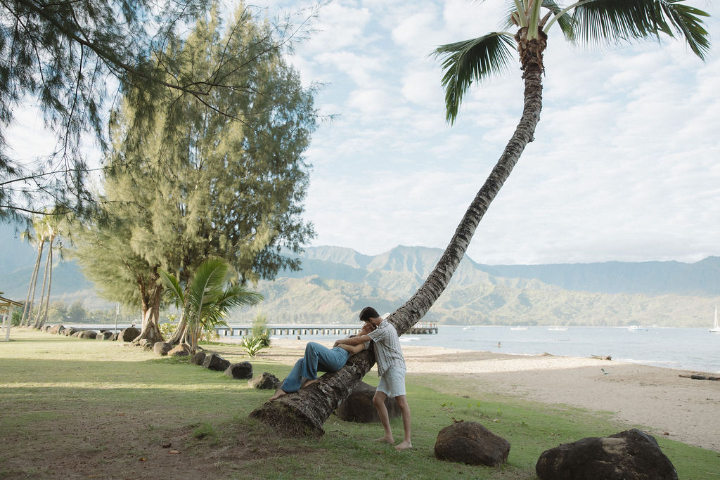 A couple on a palm tree on Hanalei Bay
